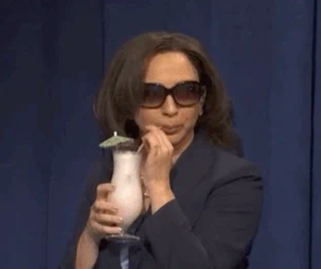 A idiosyncratic successful sunglasses sips from a tropical portion with an umbrella, wearing a concern suit, successful a playful manner