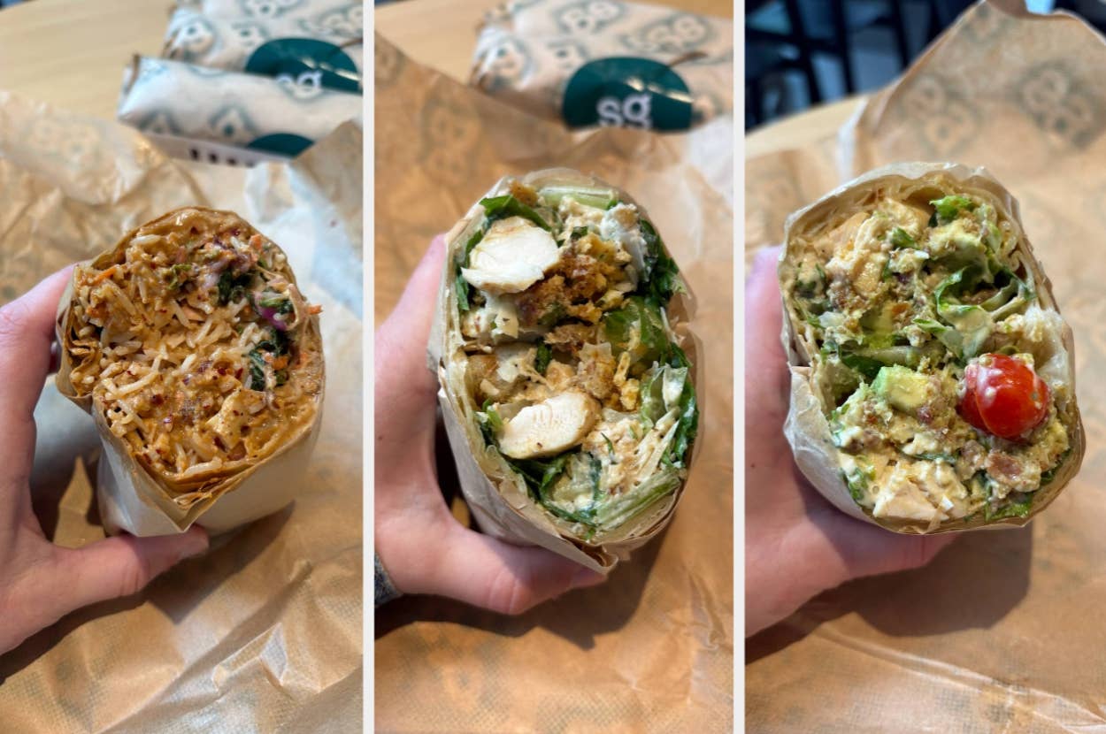 Three sandwich wraps with various fillings including meat, vegetables, and sauces, held in hands on a wrapper-covered surface