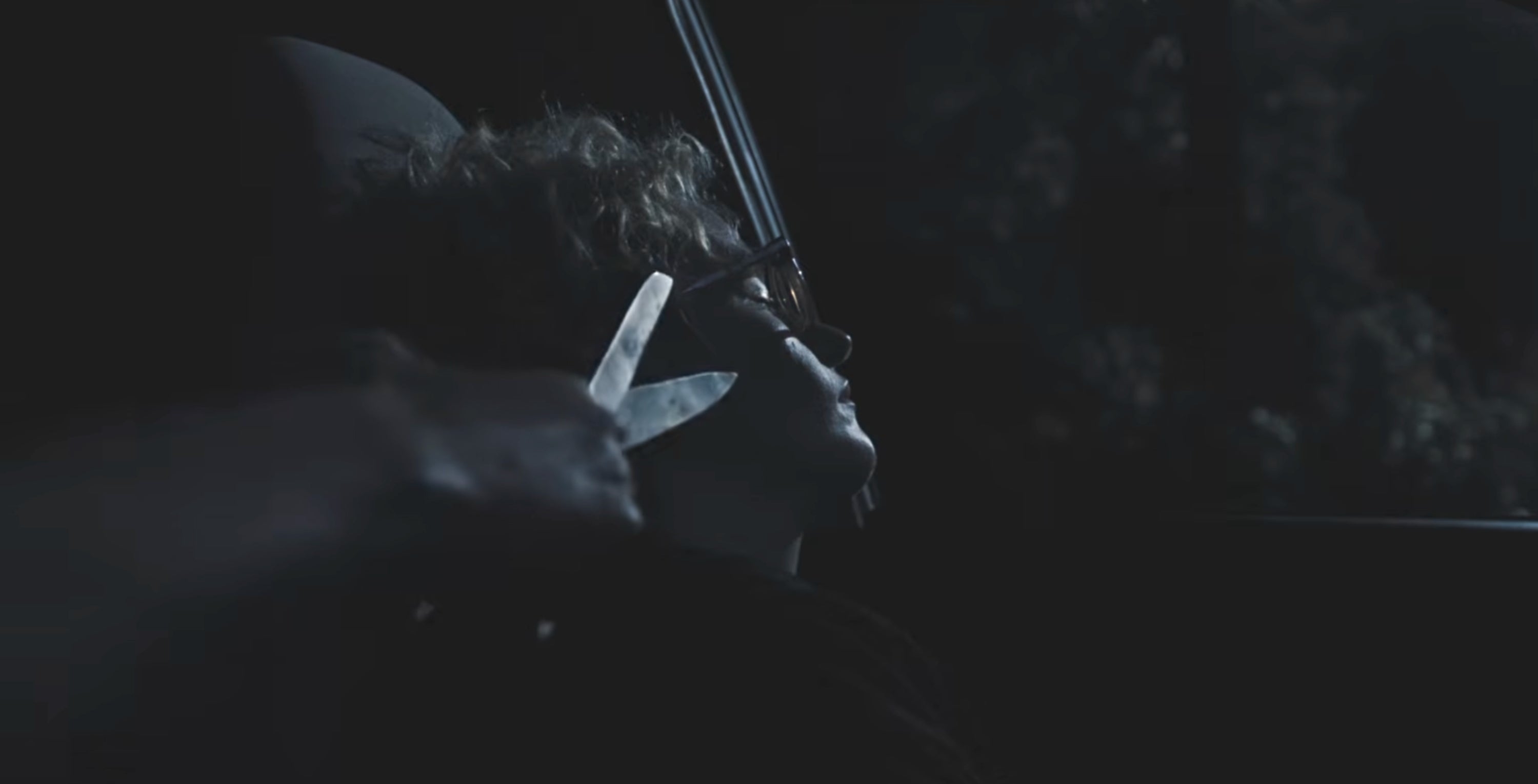 Julia Garner dormant  successful  a car   portion    a manus  with scissors approaches her head