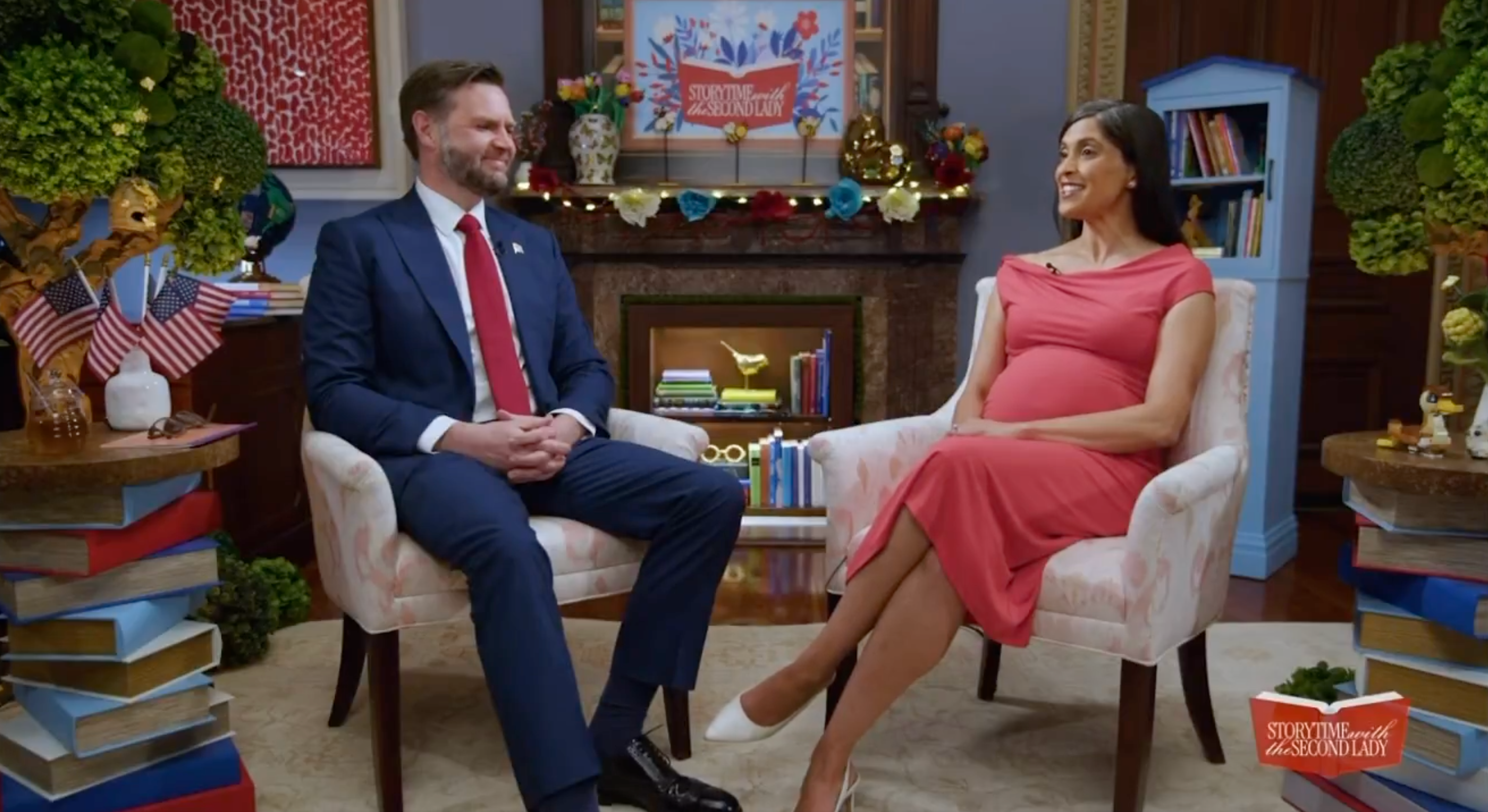 A antheral successful a suit and a pistillate successful a fitted formal are seated successful a surviving country workplace setting, smiling and engaging successful conversation
