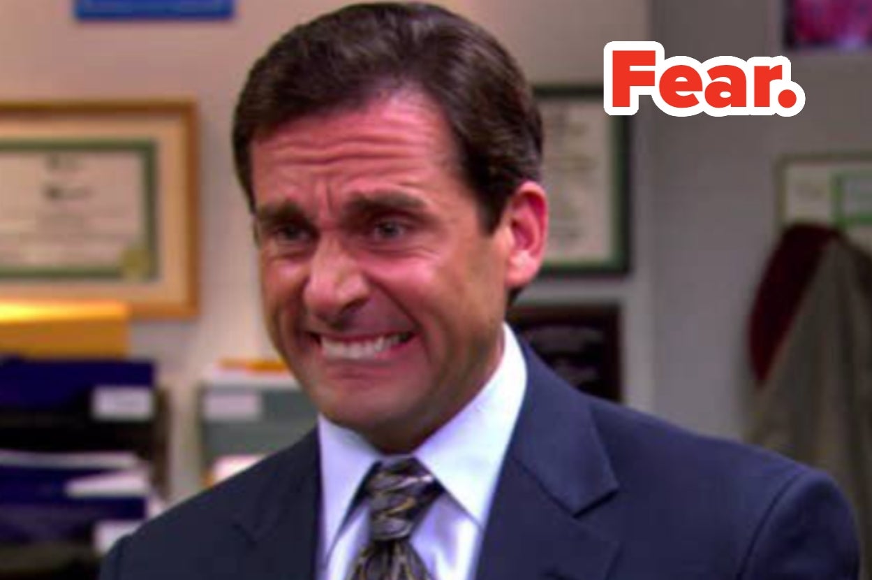 Person in office setting making an anxious expression, teeth clenched, with the word "Fear" in bold above