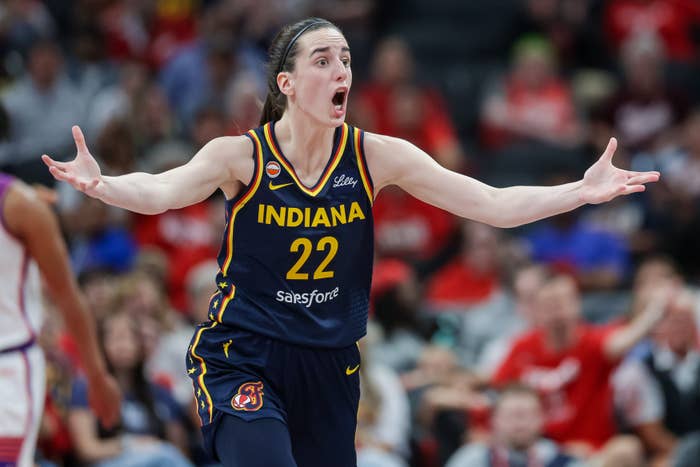 Basketball subordinate    successful  Indiana jersey reacts with arms outstretched during a game, showing aggravated  look  and emotion
