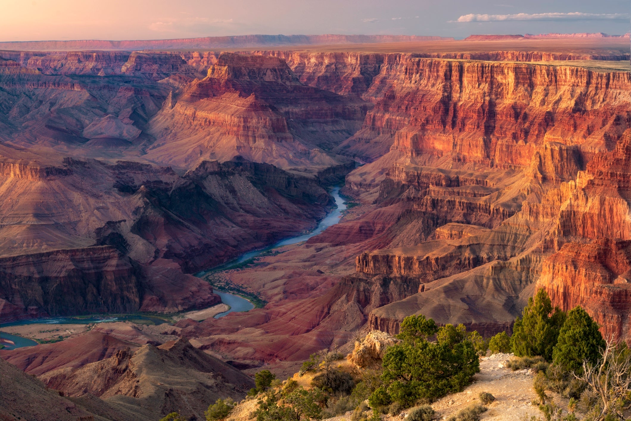 Grand Canyon presumption    with a winding stream  and layered stone  formations, creating a melodramatic  scenery  country   nether  a wide   sky