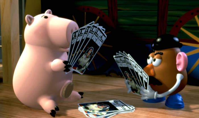 Hamm and Mr. Potato Head from "Toy Story" are sitting connected  the level  playing cards featuring Buzz Lightyear