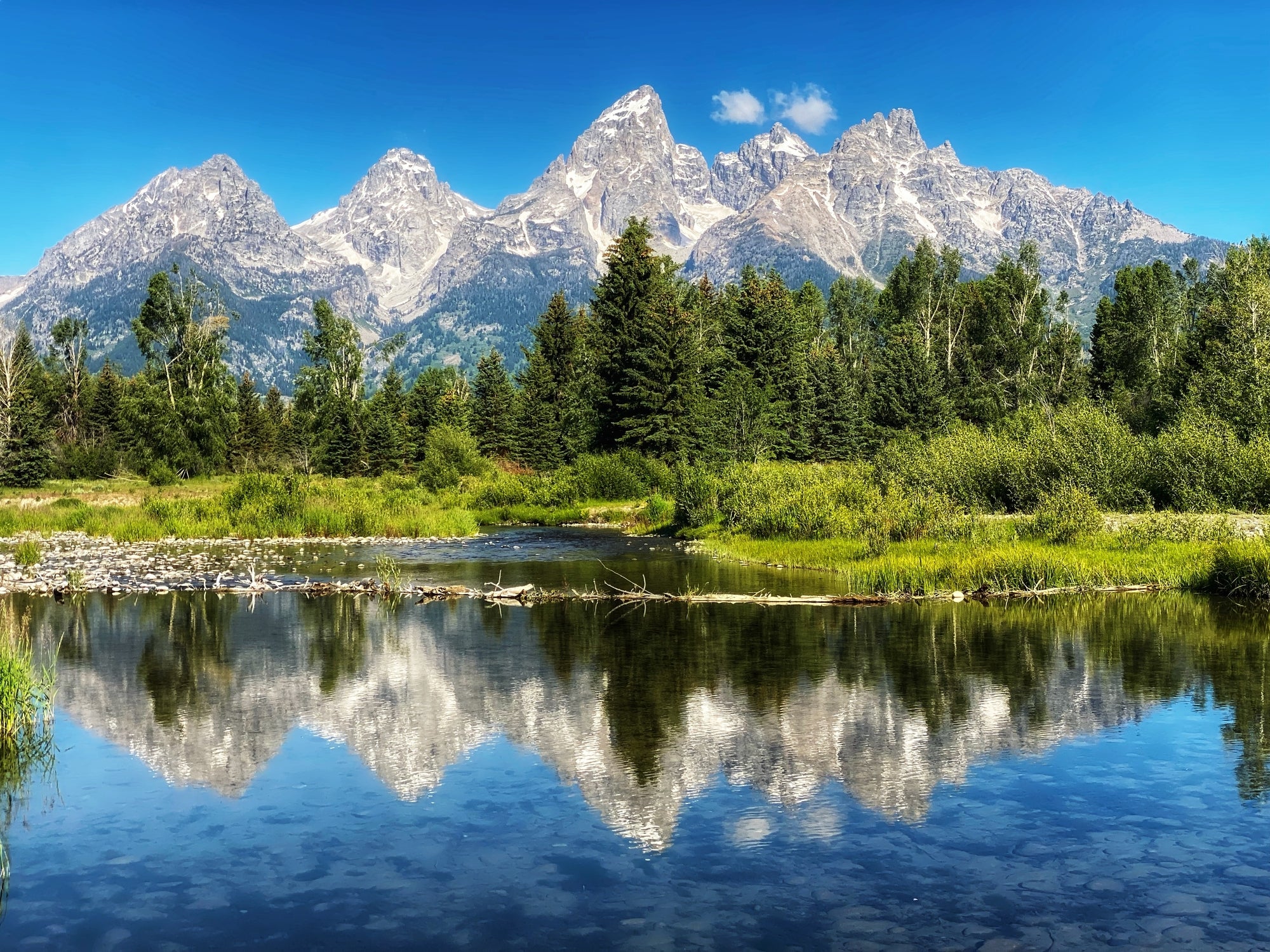 Mountain scope  reflected successful  a calm lake, surrounded by lush greenery and trees, nether  a wide   sky