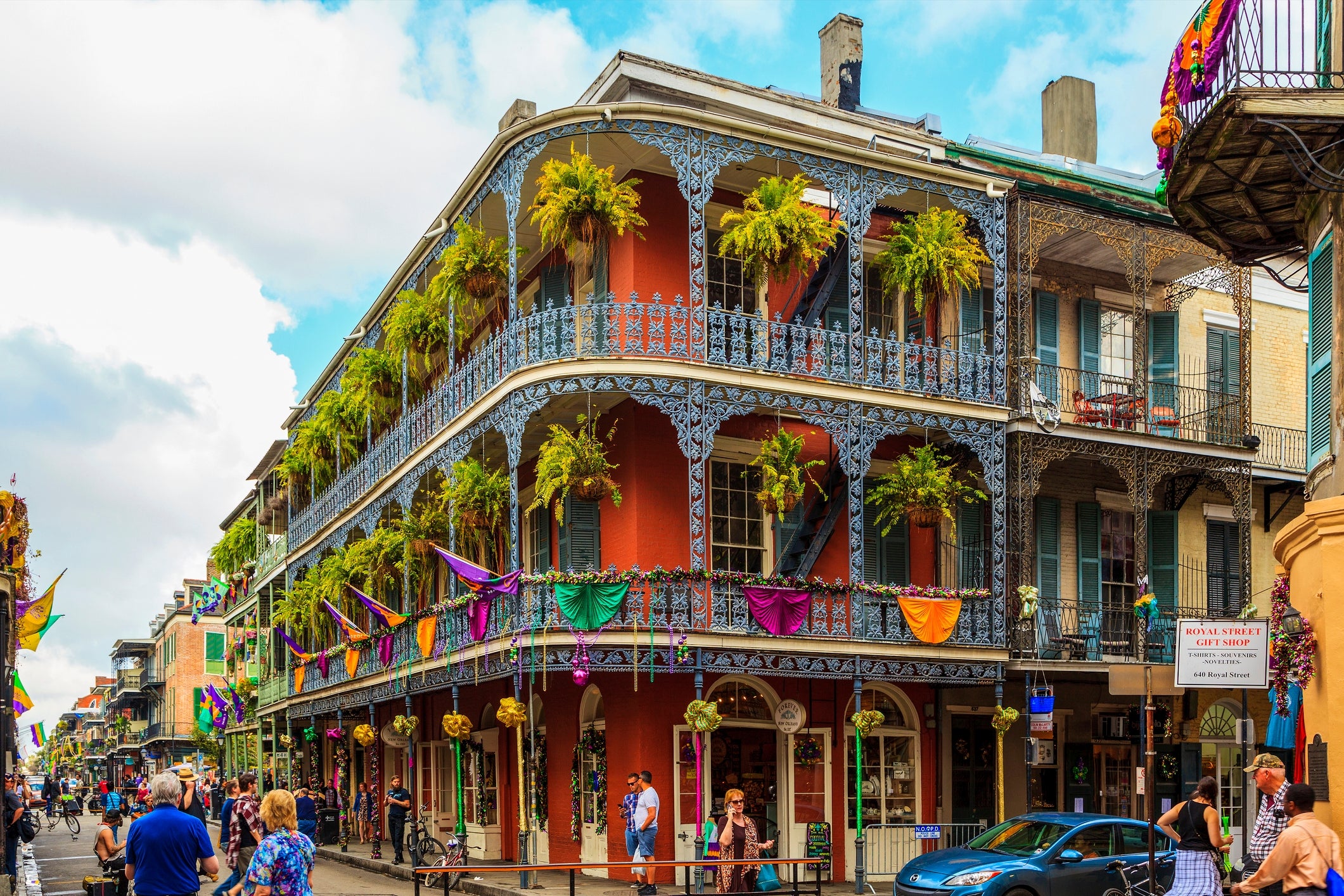 Historic New Orleans thoroughfare  with a French Quarter gathering  adorned with wrought robust  balconies and vibrant hanging plants