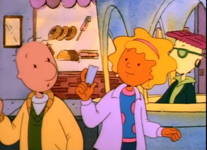 Animated characters Doug and Patti converse in a bakery. Skeeter is in the background wearing sunglasses