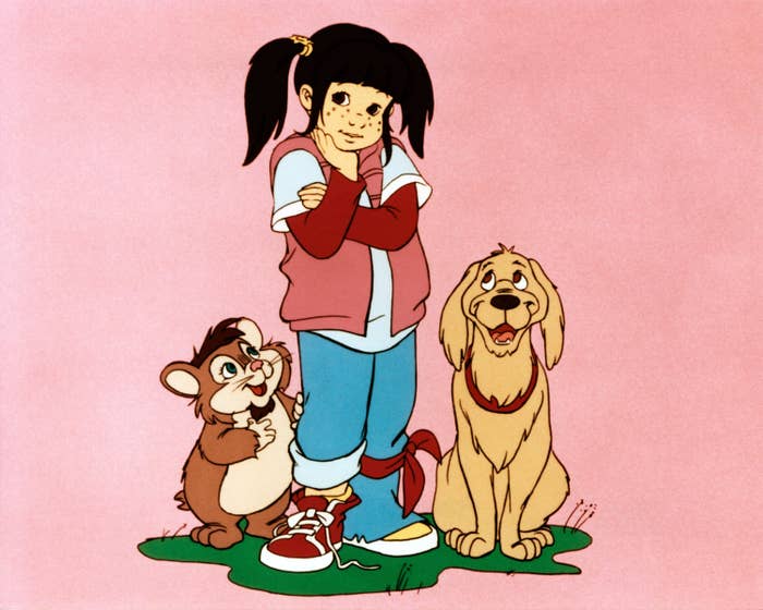 Animated girl with pigtails, wearing casual clothes, stands with a happy chipmunk and a cheerful dog