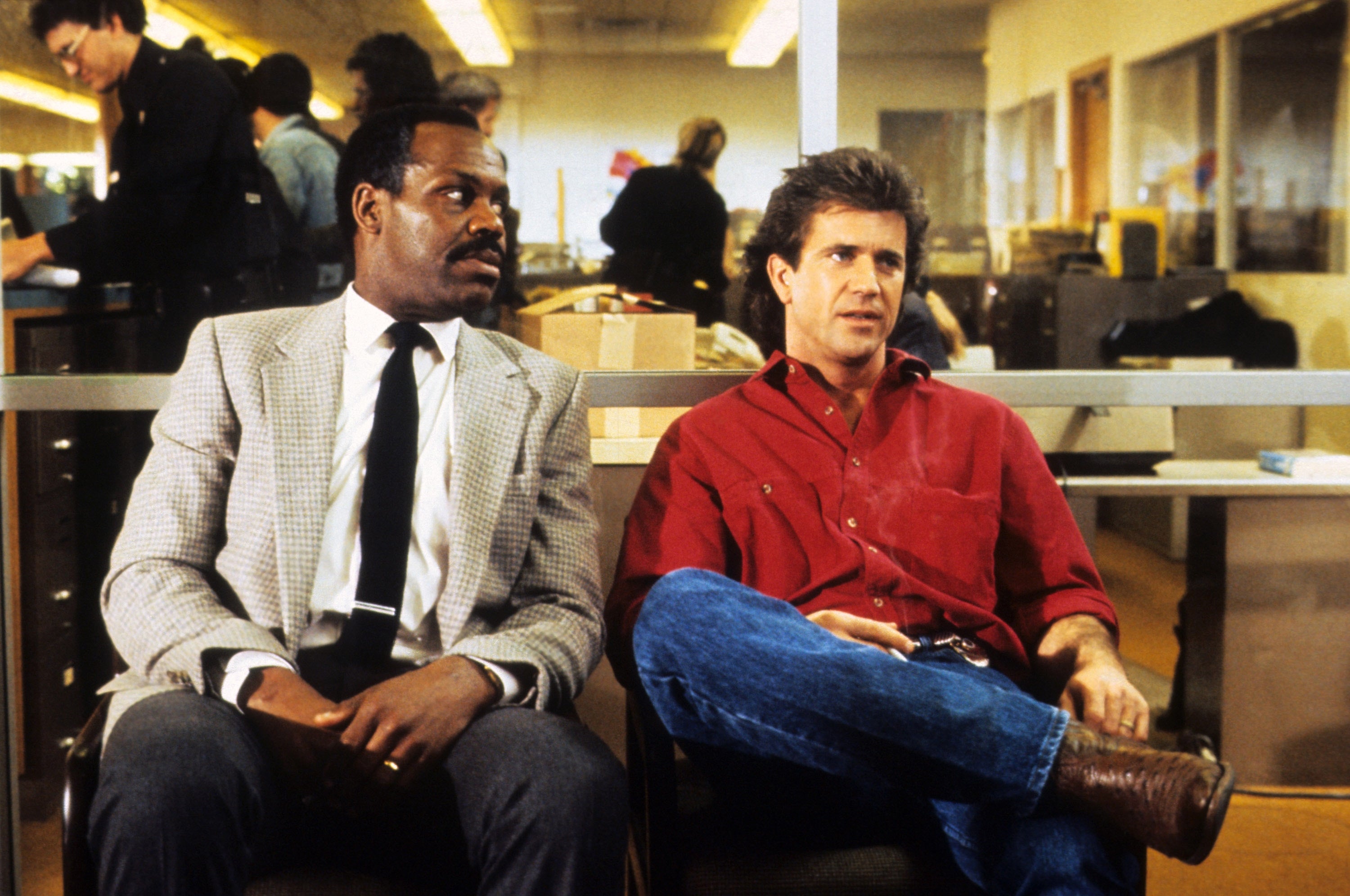 Two actors beryllium   successful  a constabulary  presumption    set; 1  wears a checkered blazer, the different   a casual garment  and jeans, from a country   successful  a fashionable  enactment   film