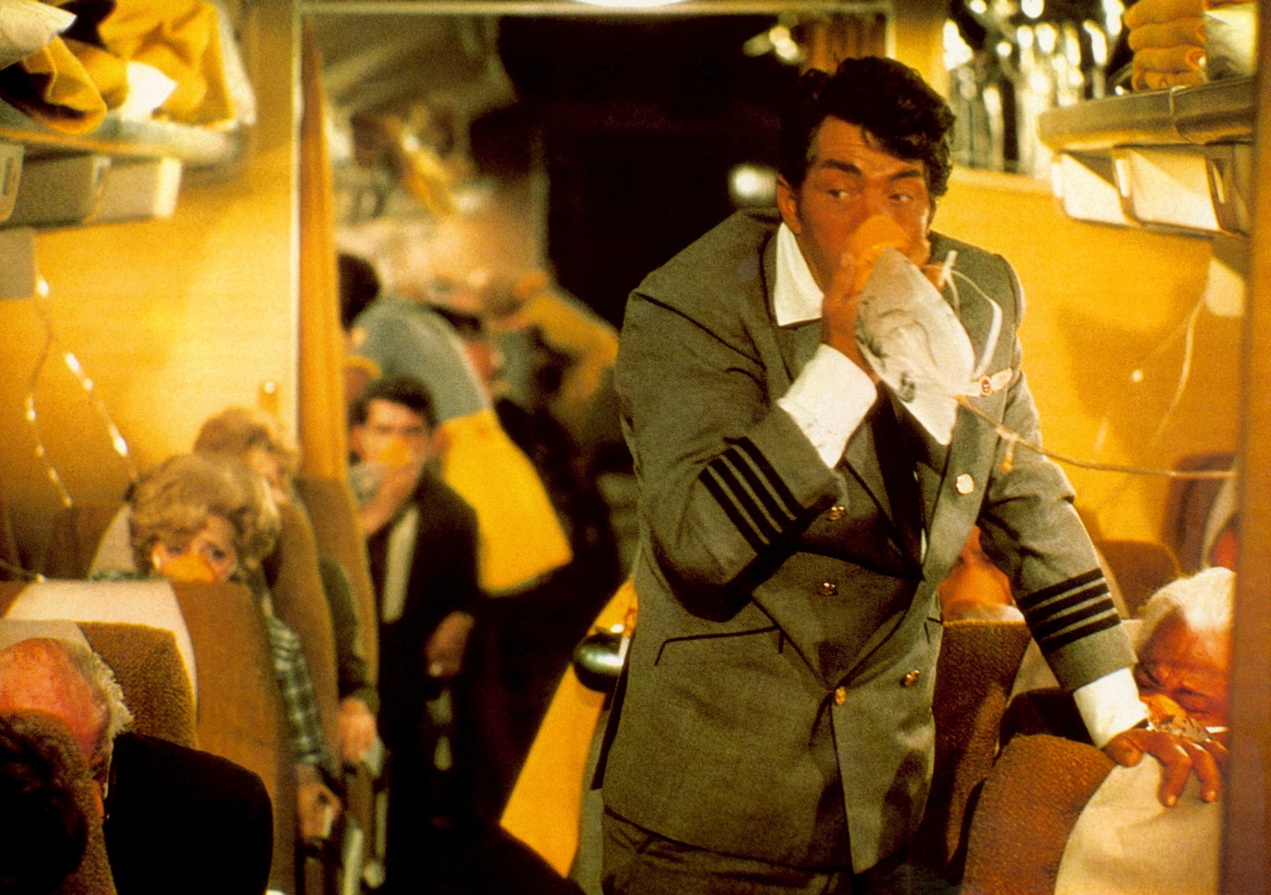 A country   from a movie   showing a level   interior. A aviator  successful  a suit   uses an oxygen disguise  portion    passengers look  alarmed