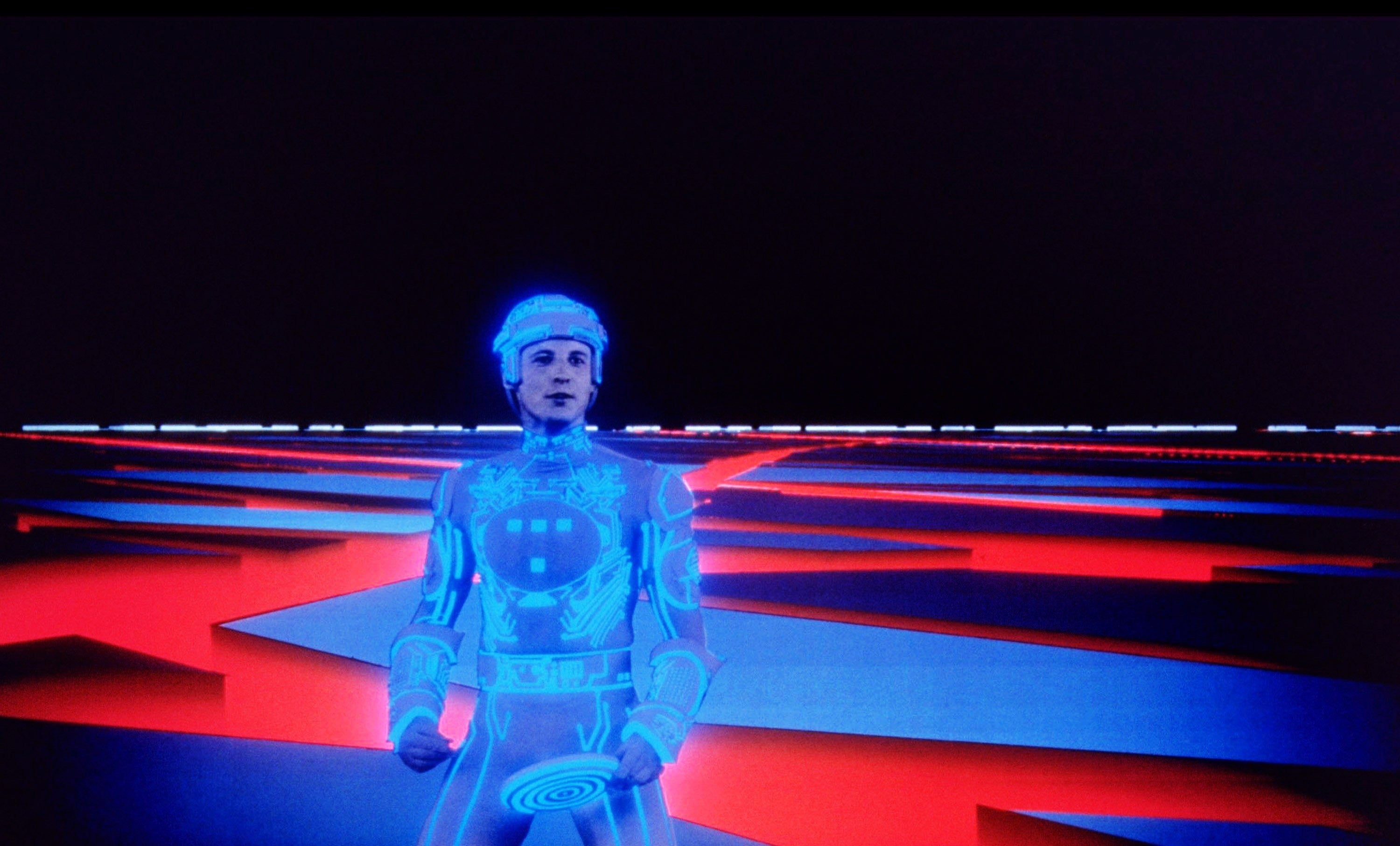 A idiosyncratic   successful  a futuristic, glowing suit   stands successful  a integer  scenery  with geometric patterns, resembling a country   from a sci-fi movie