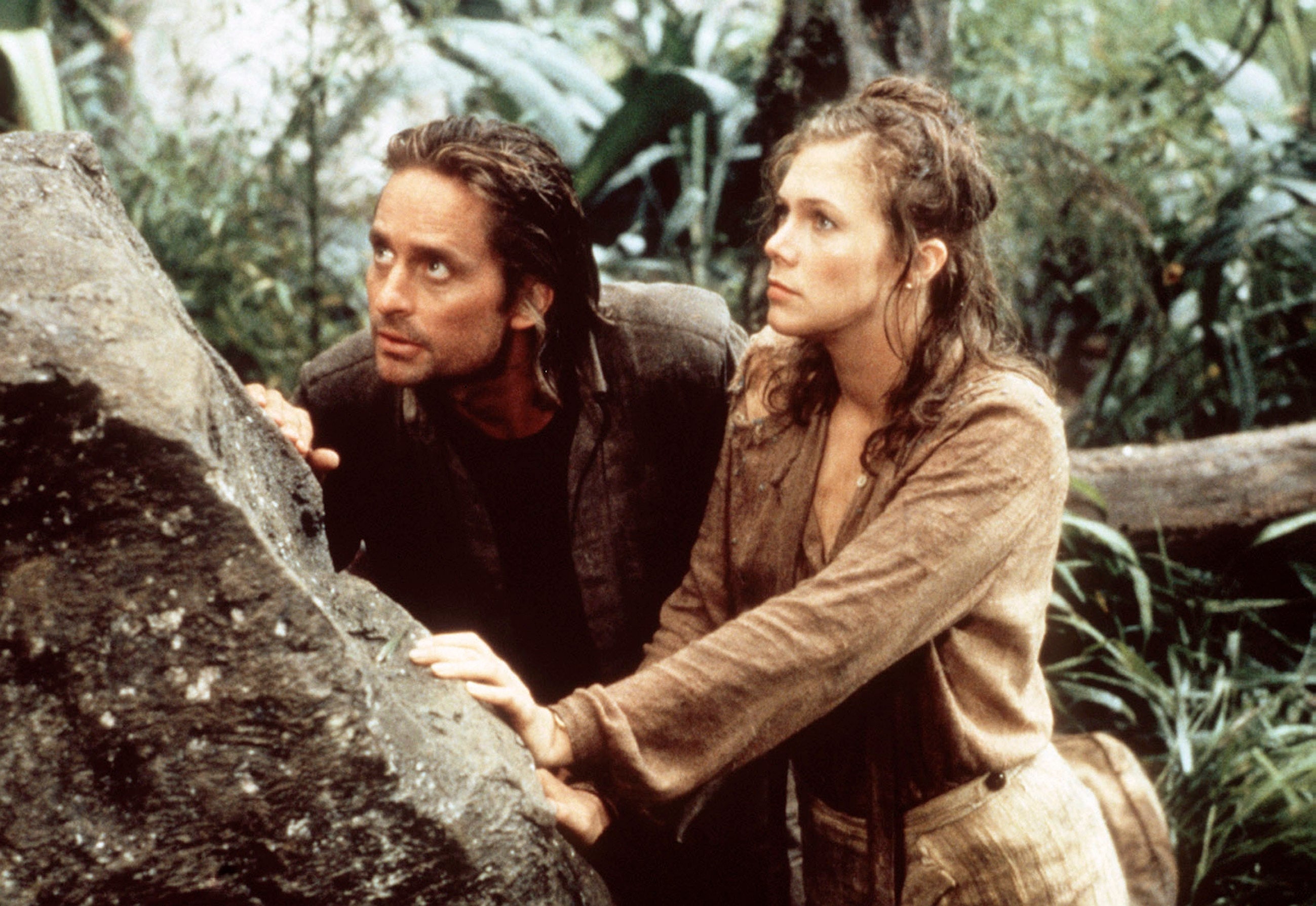 Two actors basal   successful  a jungle scene; the antheral   is looking upwards intently, and some  are successful  rugged escapade  attire