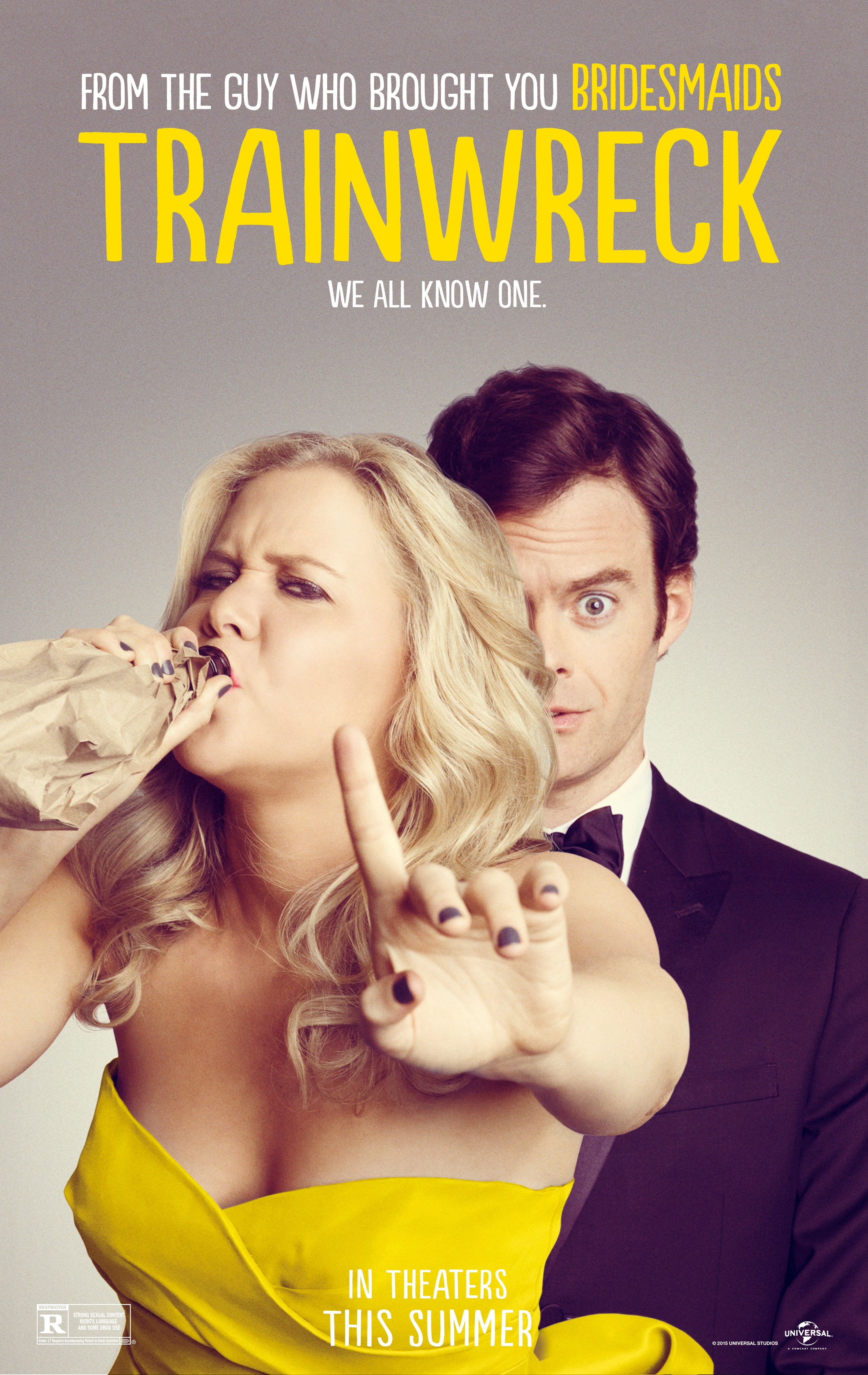 Movie poster for "Trainwreck" featuring Amy Schumer drinking and gesturing to stop and Bill Hader looking surprised behind her