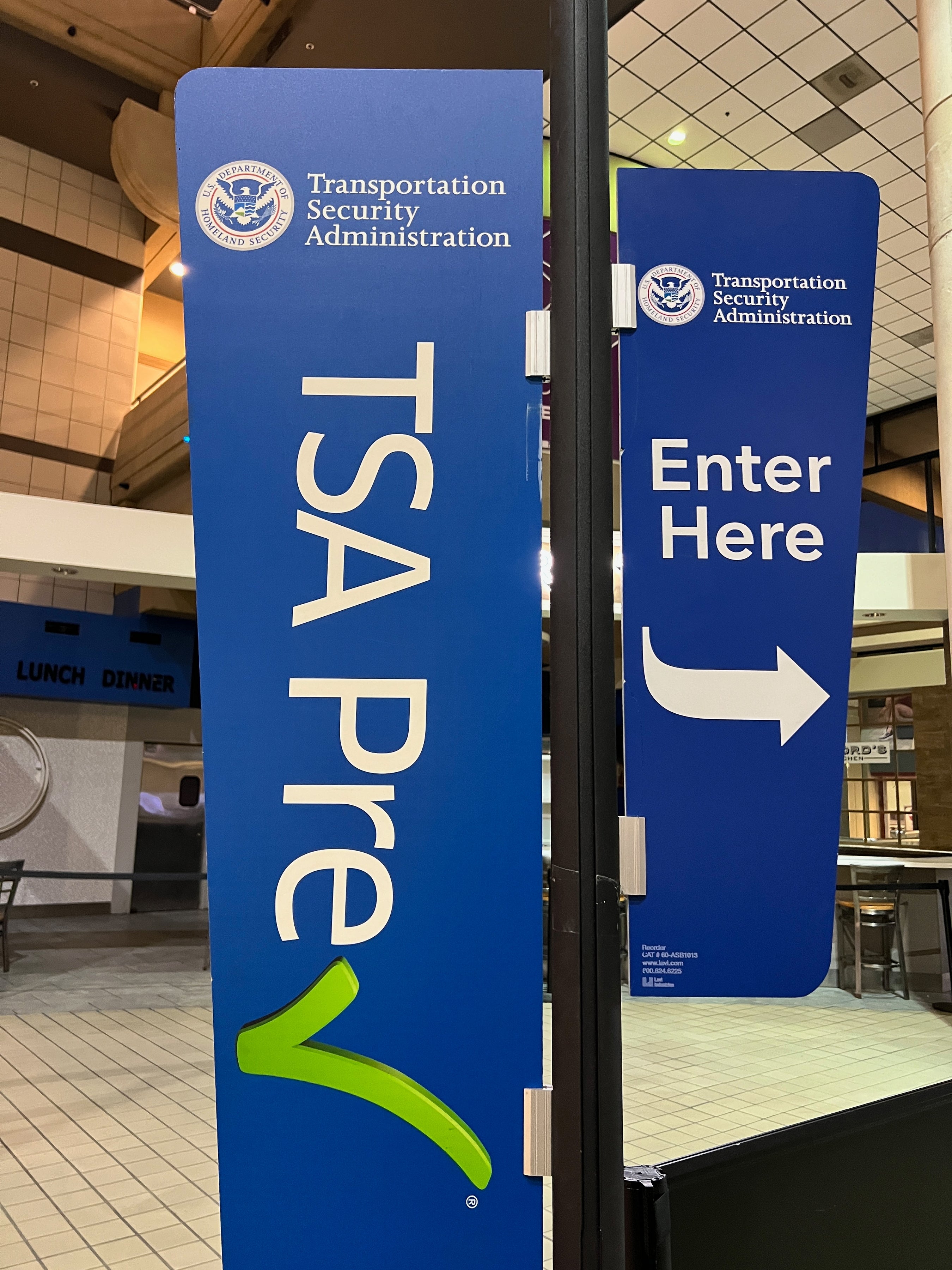 TSA PreCheck enactment     astatine  an airdrome  with signs directing passengers to enter