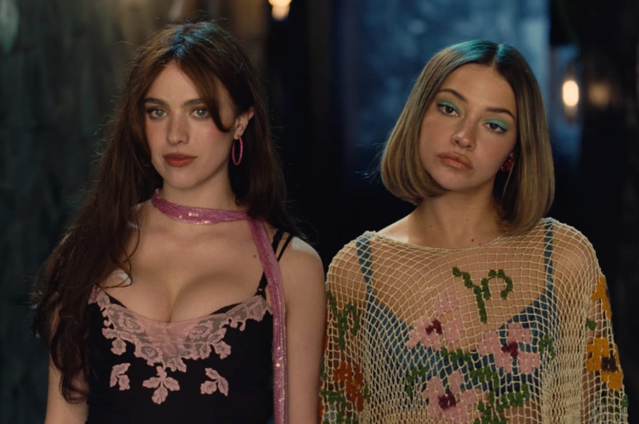 Margaret Qualley and Madelyn Cline dressed in fashionable outfits with floral and lace details, standing side by side indoors in "House Tour" music video