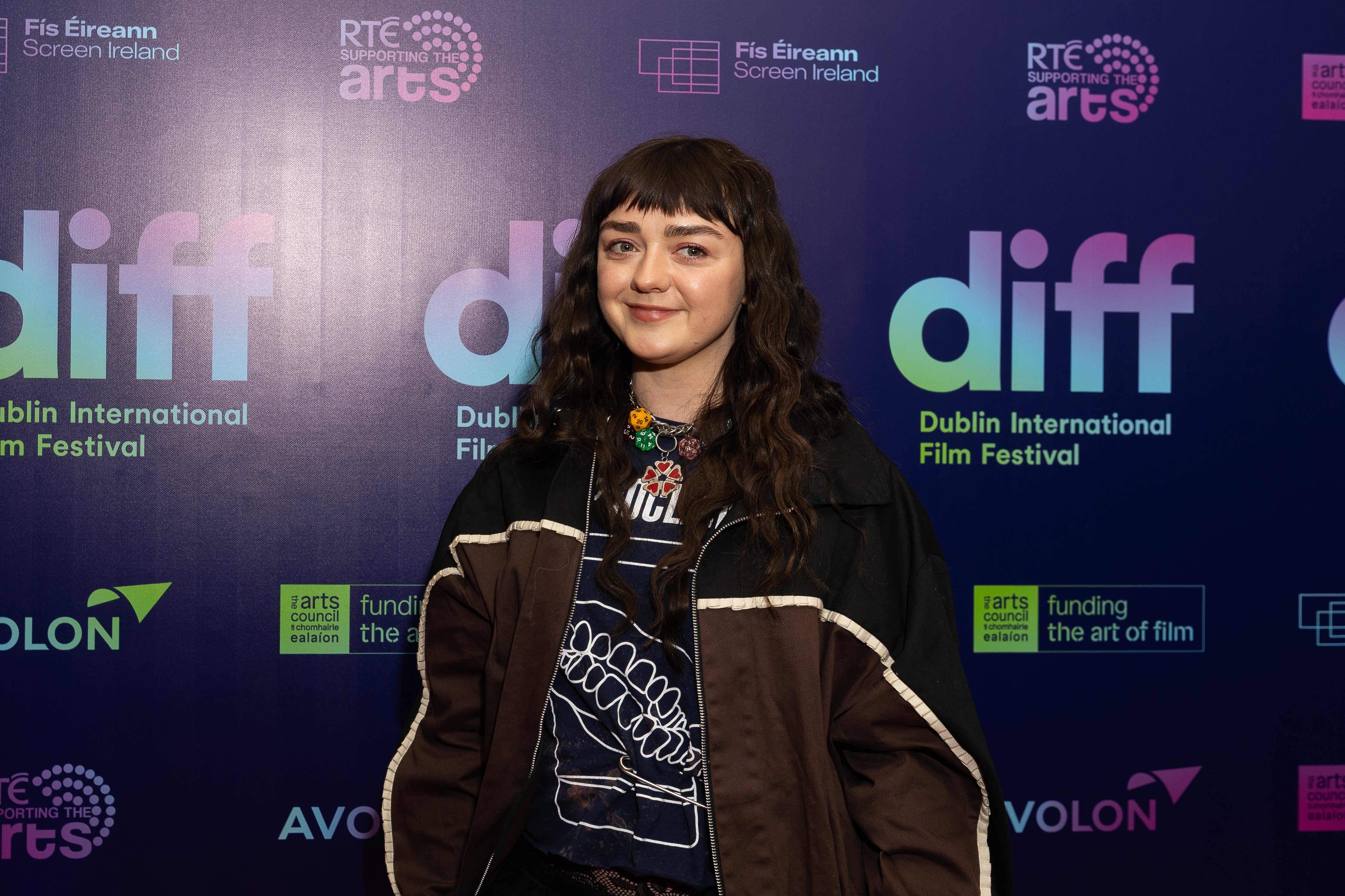 Maisie Williams in a casual jacket and graphic tee at Dublin International Film Festival event backdrop