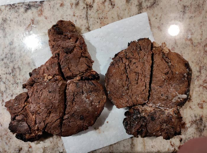 Two sliced-up steaks placed on a granite countertop