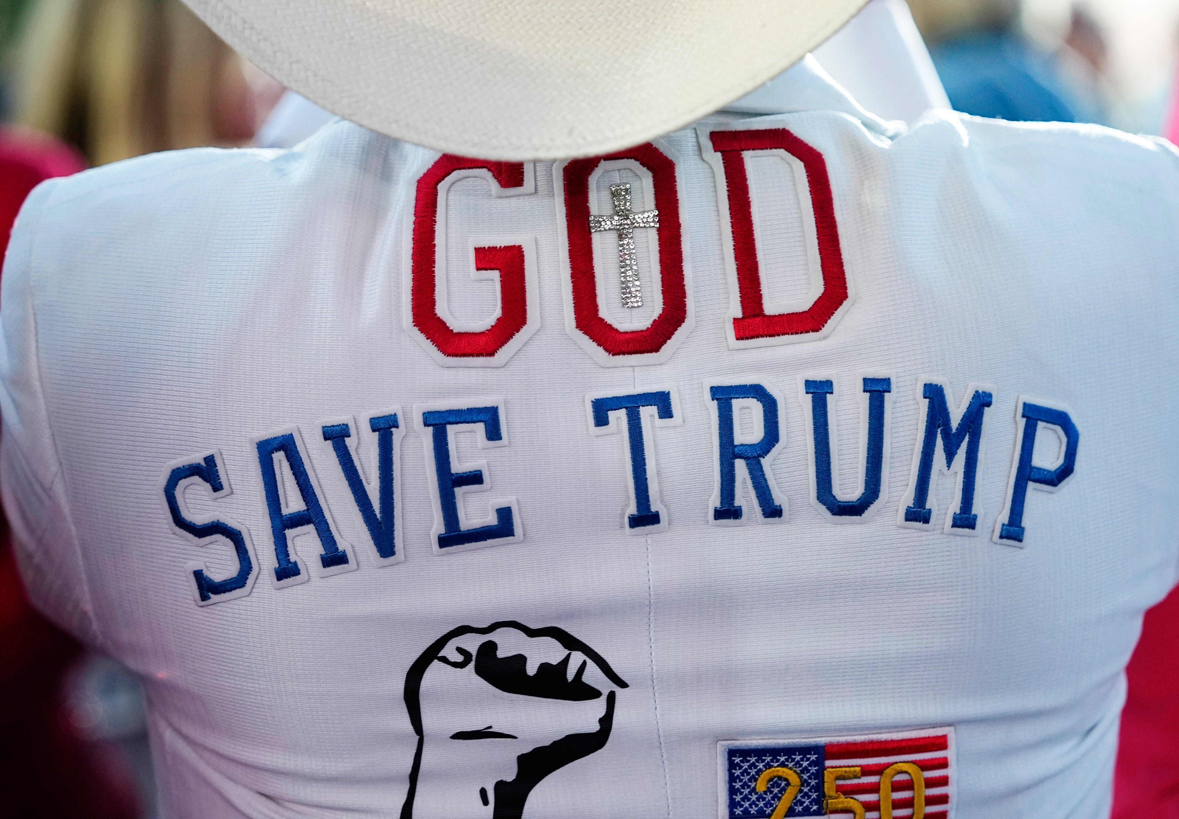 Back of a overgarment with the words "God Save Trump" and a fist below, featuring a transverse and emblem spot detail