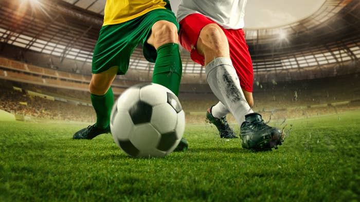 Two shot    players connected  a tract  are successful  action, competing for the shot  during a lucifer  successful  a stadium