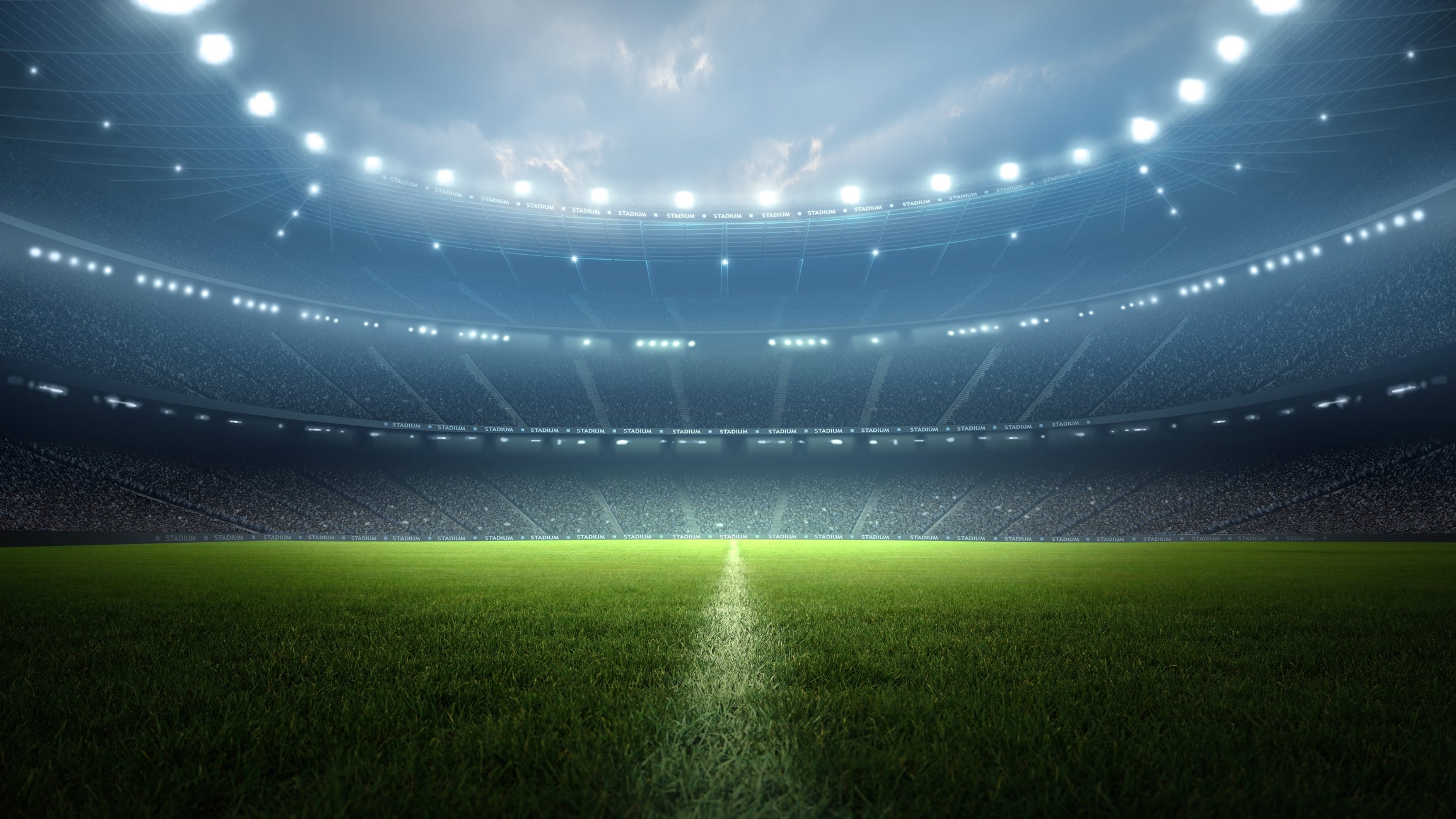 Illuminated stadium astatine  nighttime  with an bare  tract  and a melodramatic  sky. Silhouettes of seating areas are faintly disposable   successful  the background