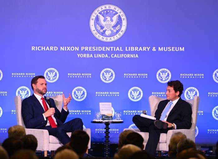 Two radical   seated connected  signifier    astatine  a treatment  event, with a Richard Nixon Foundation backdrop
