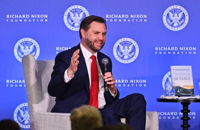 Person successful  a suit   speaking connected  signifier    astatine  a Richard Nixon Foundation event, with a publication  titled "Hillbilly Elegy" connected  a tiny  array  beside him