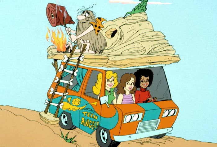 Animated characters in a prehistoric themed van labeled "Teen Angels," with a caveman on the roof holding a club