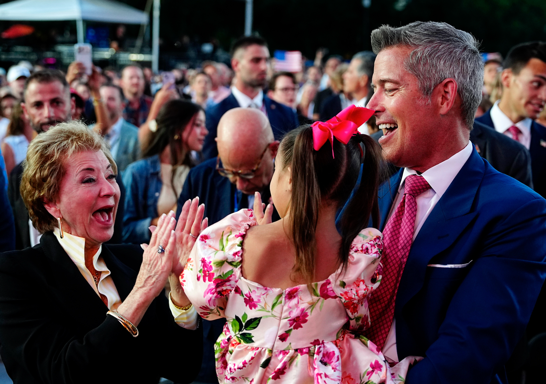 Sean Duffy holding his girl  surrounded by smiling radical   astatine  a lively event