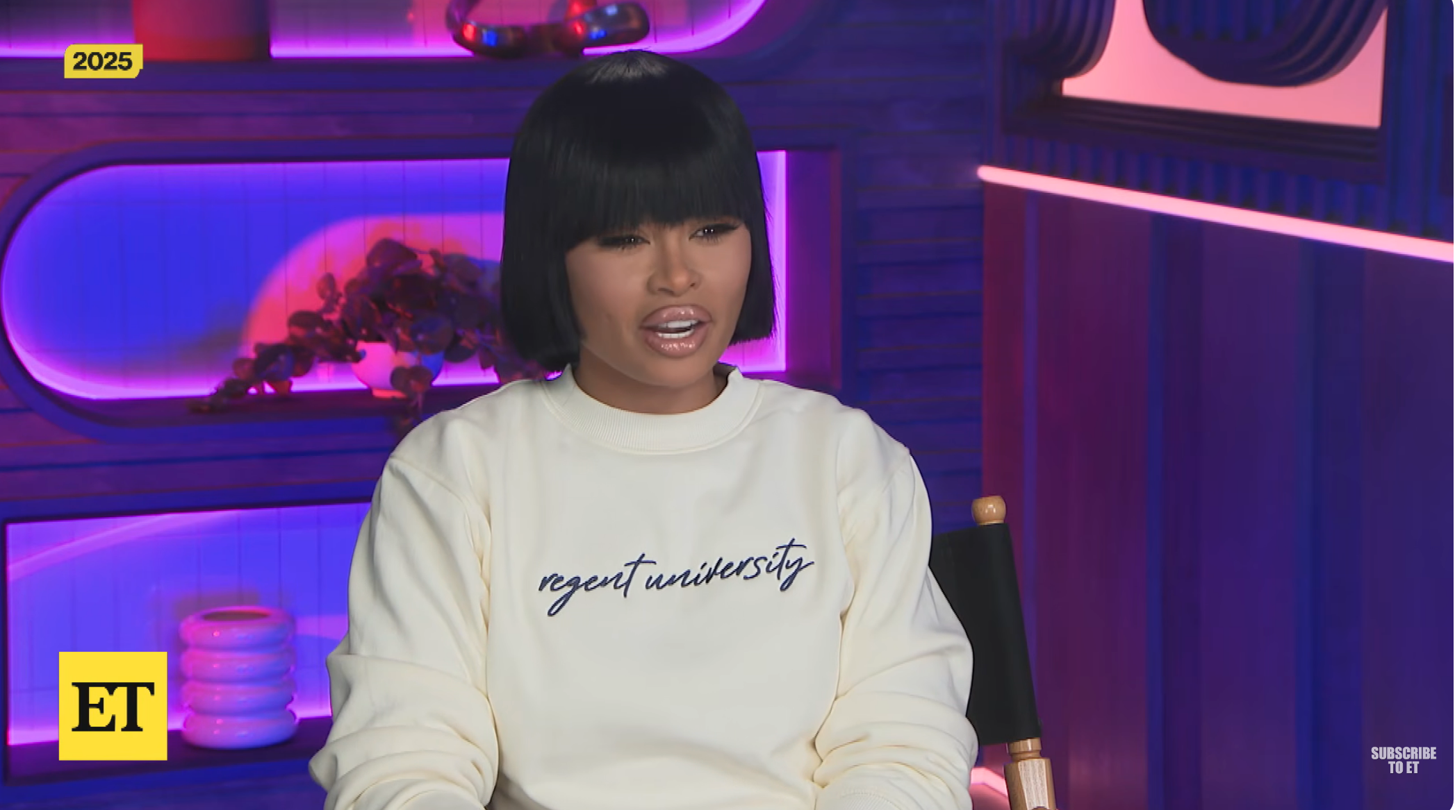 Blac Chyna with bangs seated, wearing a sweatshirt for regent university