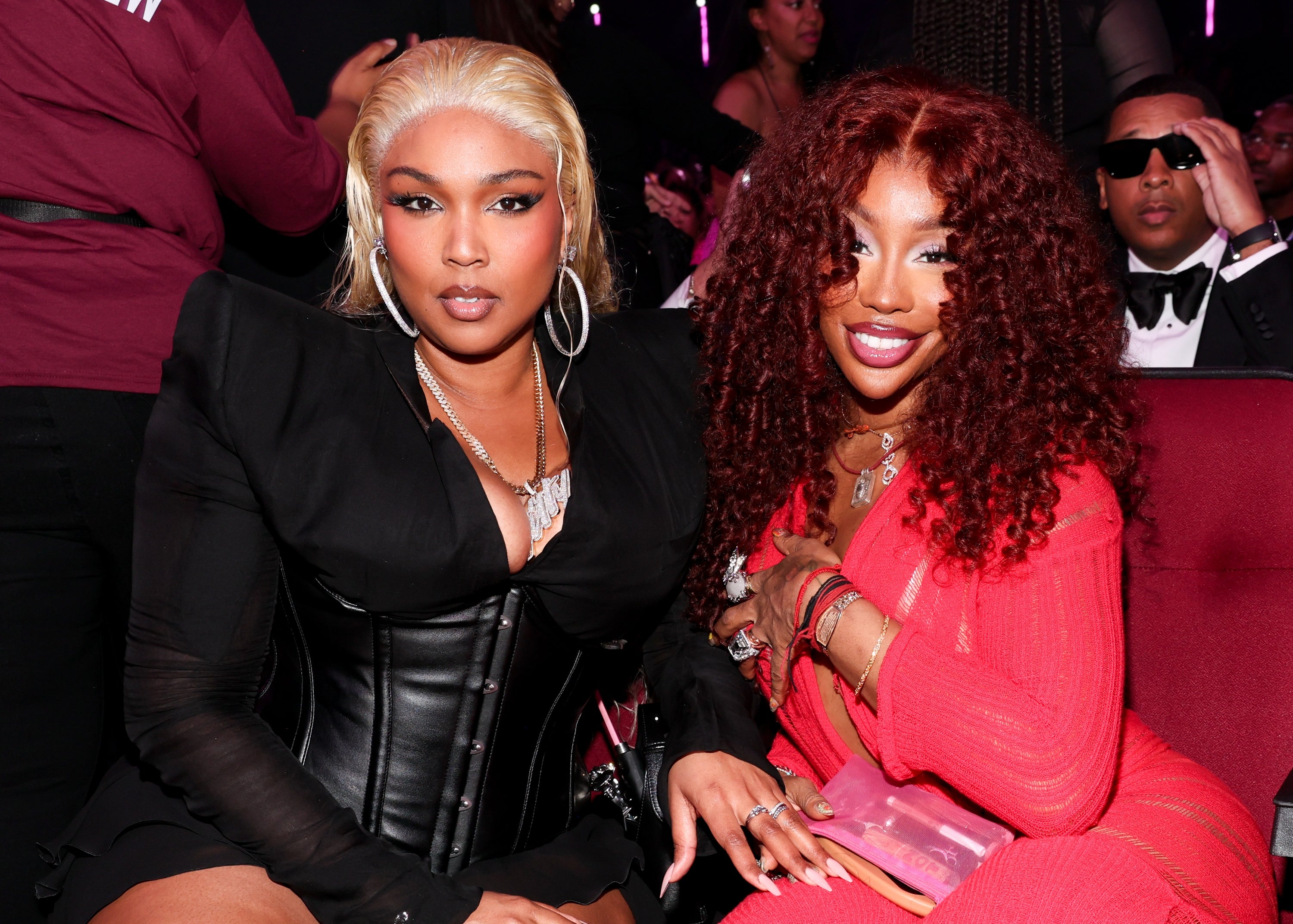 Lizzo and SZA pose at an event