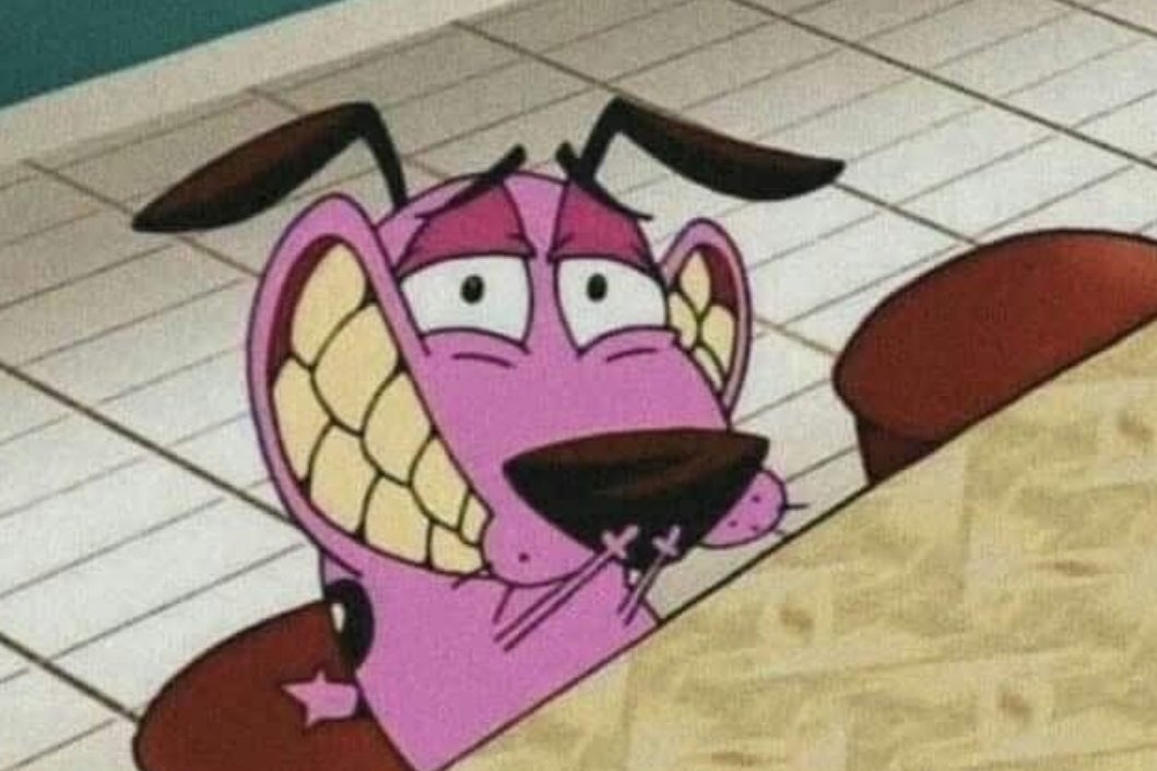 Cartoon dog with anxious expression sits behind a table, displaying large, exaggerated teeth