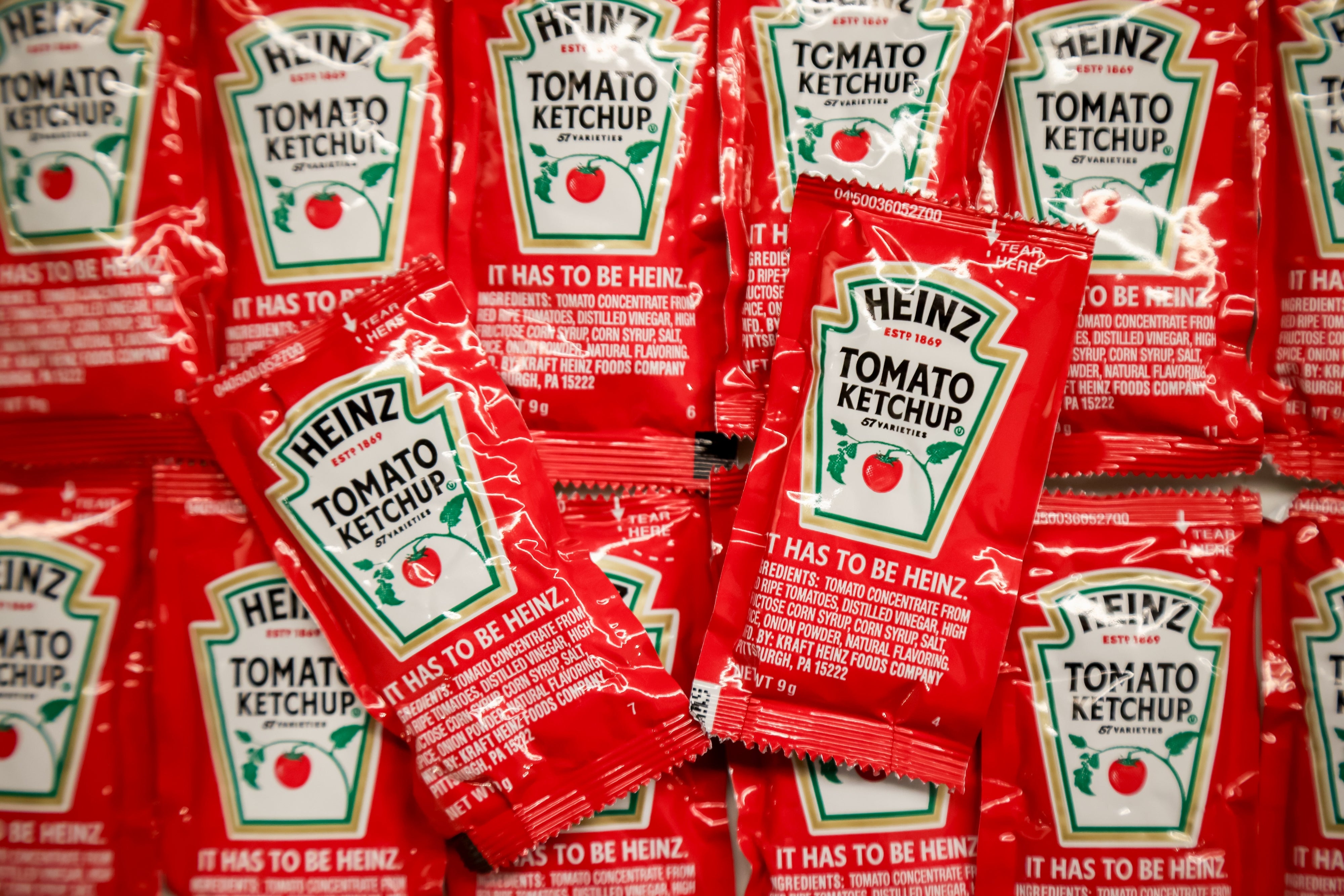 Heinz ketchup packets arranged closely, showcasing the logo and the substance "It has to beryllium Heinz."