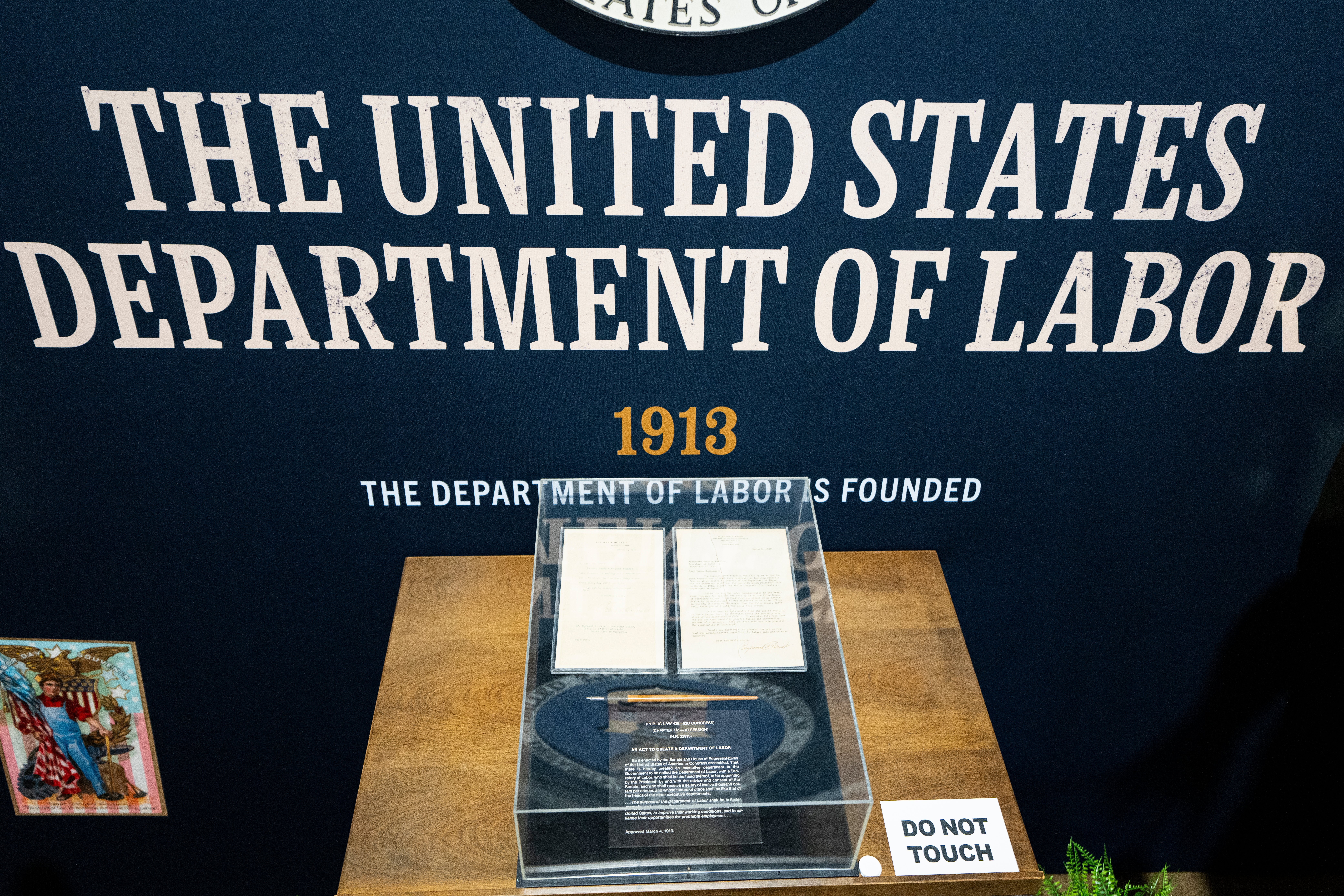 Exhibit of the U.S. Department of Labor founding documents, 1913, displayed successful a solid lawsuit with a "Do Not Touch" sign