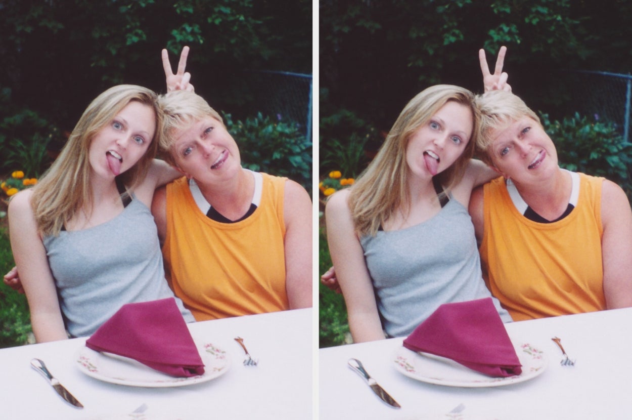 Two women make playful bunny ears at a table outdoors, smiling and showing lighthearted expressions