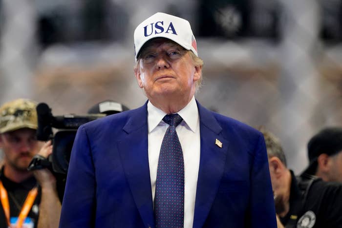 Person successful  a suit   and necktie  wearing a headdress  with "USA" connected  it, lasting  successful  beforehand   of a blurred background