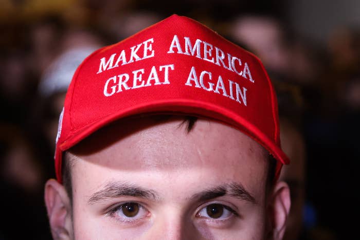 Person wearing a headdress  with the operation   "Make America Great Again" successful  achromatic  text