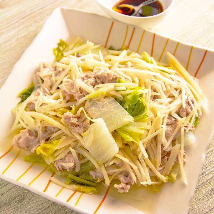 皿に盛り付けられた、蒸してくたくたになった白菜と豚こま切れ肉、千切りの新しょうが。横にはポン酢しょうゆの小皿が添えられている。