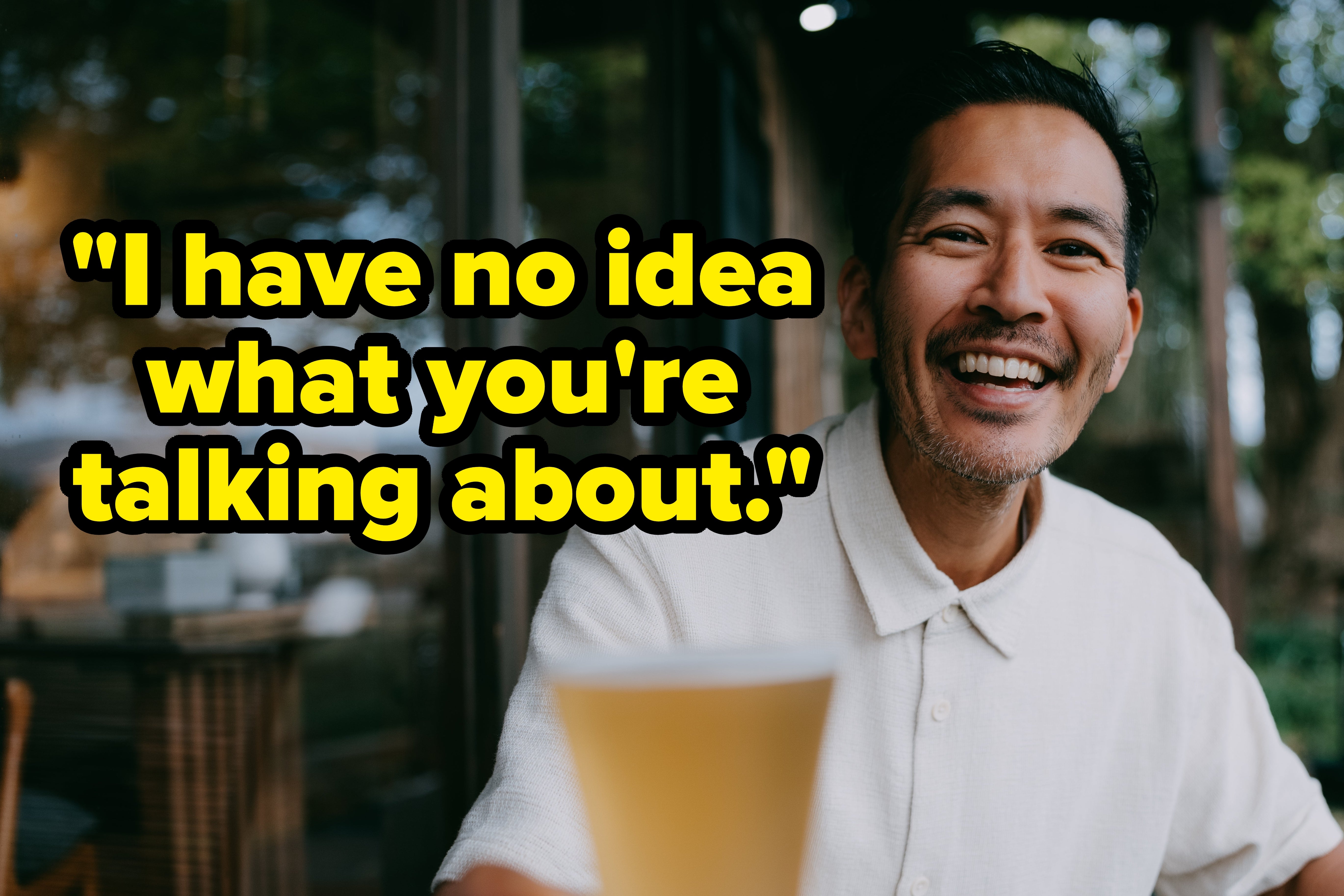 Person smiling portion holding a portion extracurricular astatine a cafe, conveying a consciousness of happiness and relaxation