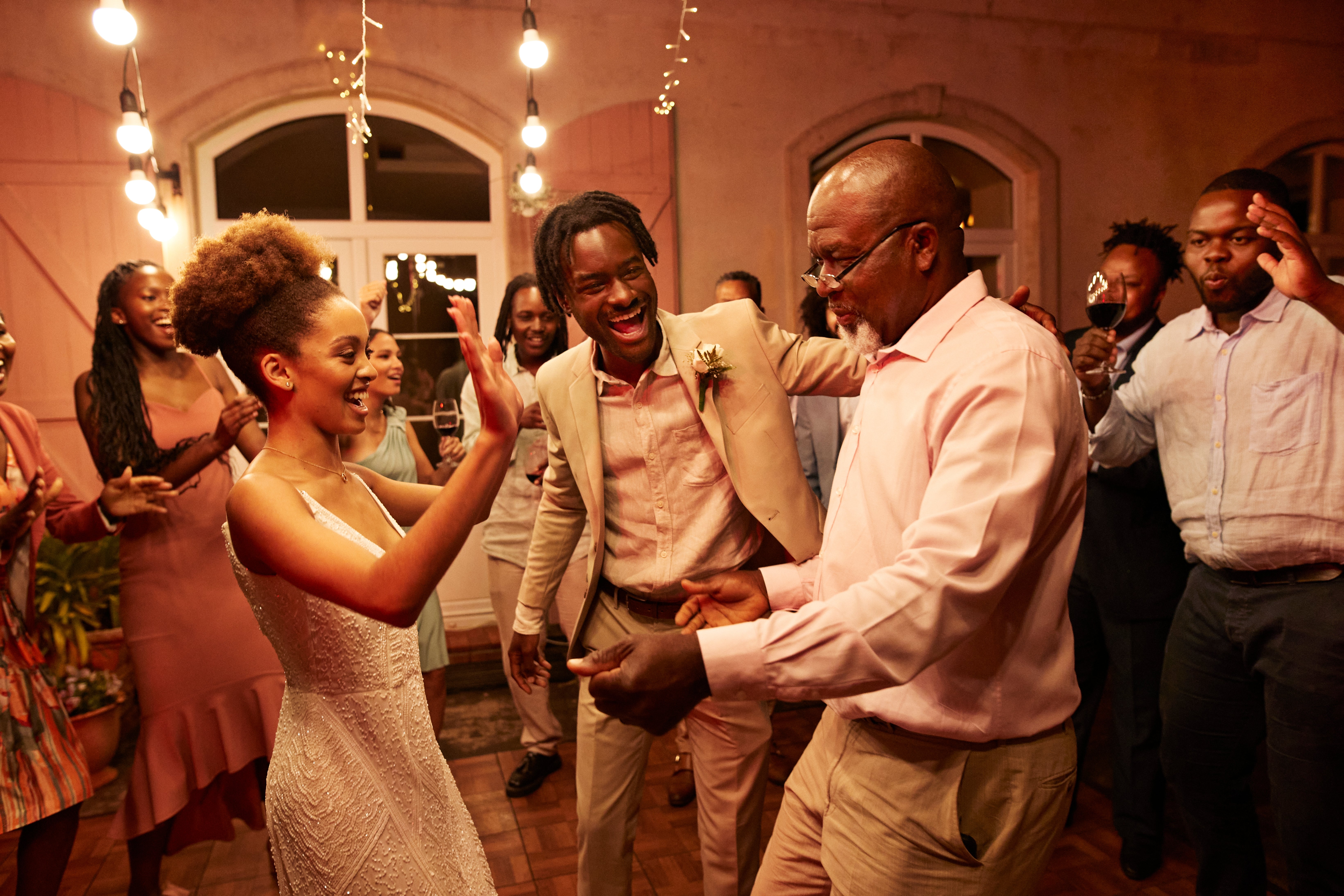 People joyfully dancing astatine a celebration, wearing elegant attire