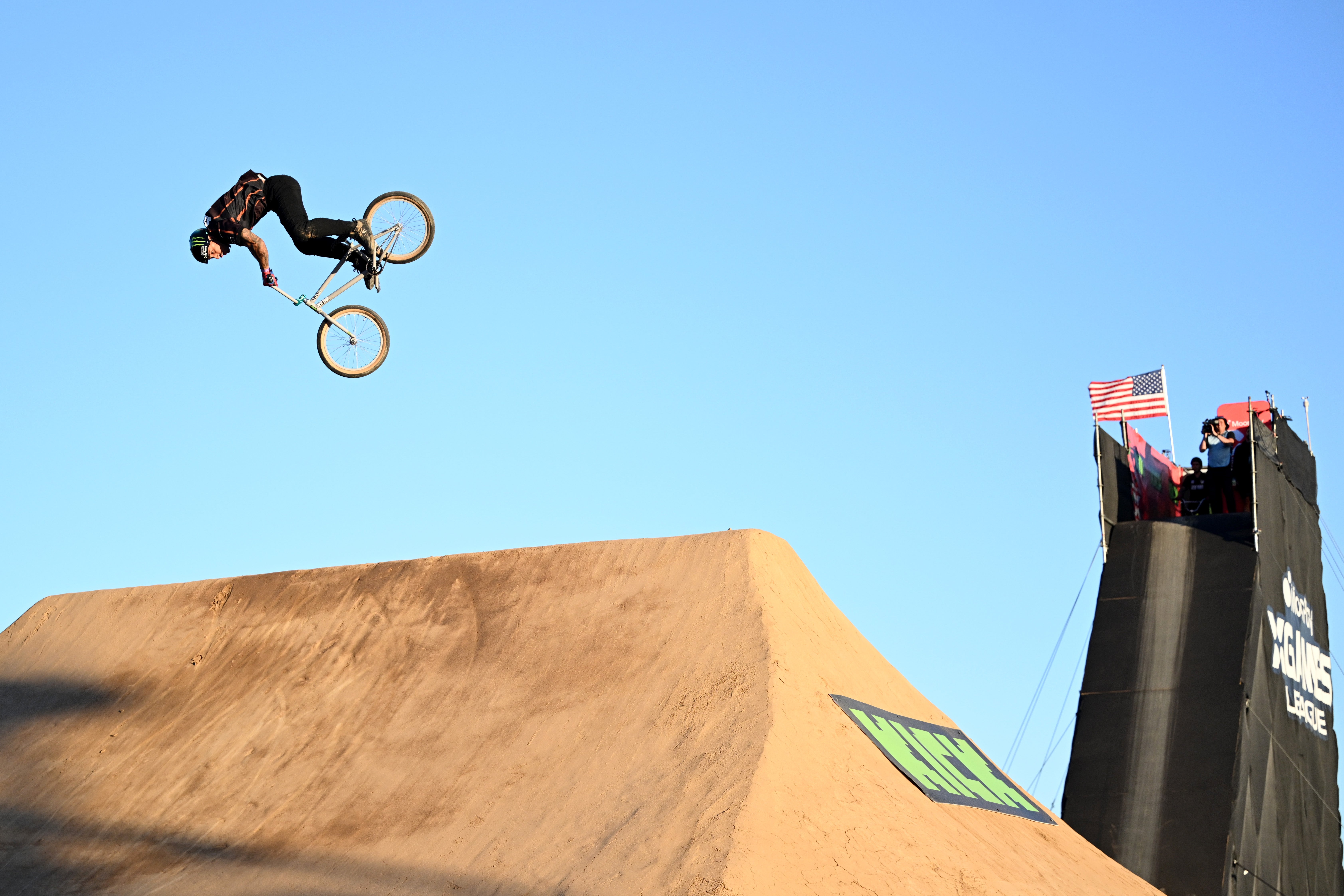 Person performing an aerial BMX instrumentality   connected  a ample  ungraded  ramp, with a bluish  entity  successful  the background
