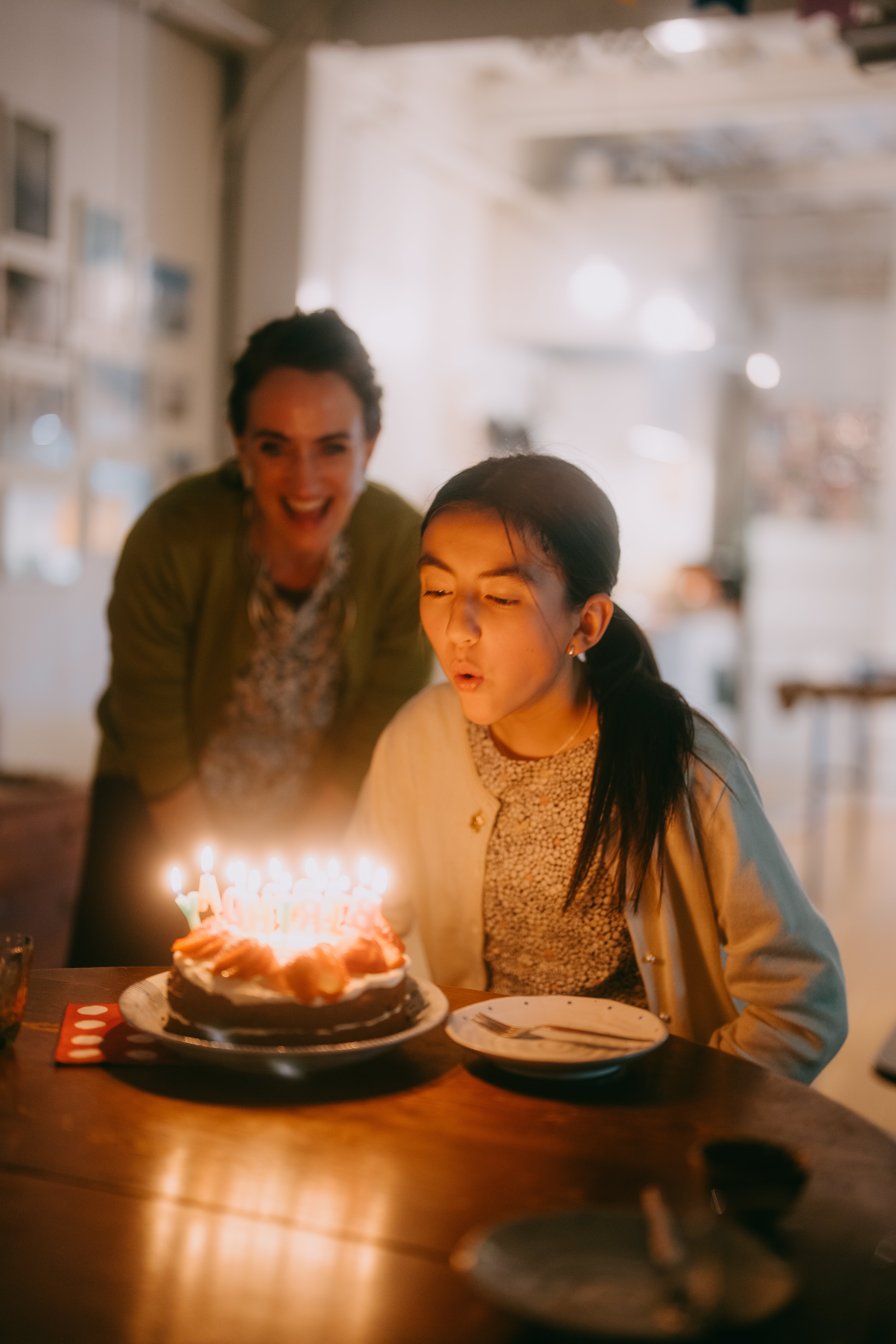 A young idiosyncratic blowing retired candles connected a day barroom arsenic different idiosyncratic joyfully watches successful a cozy setting