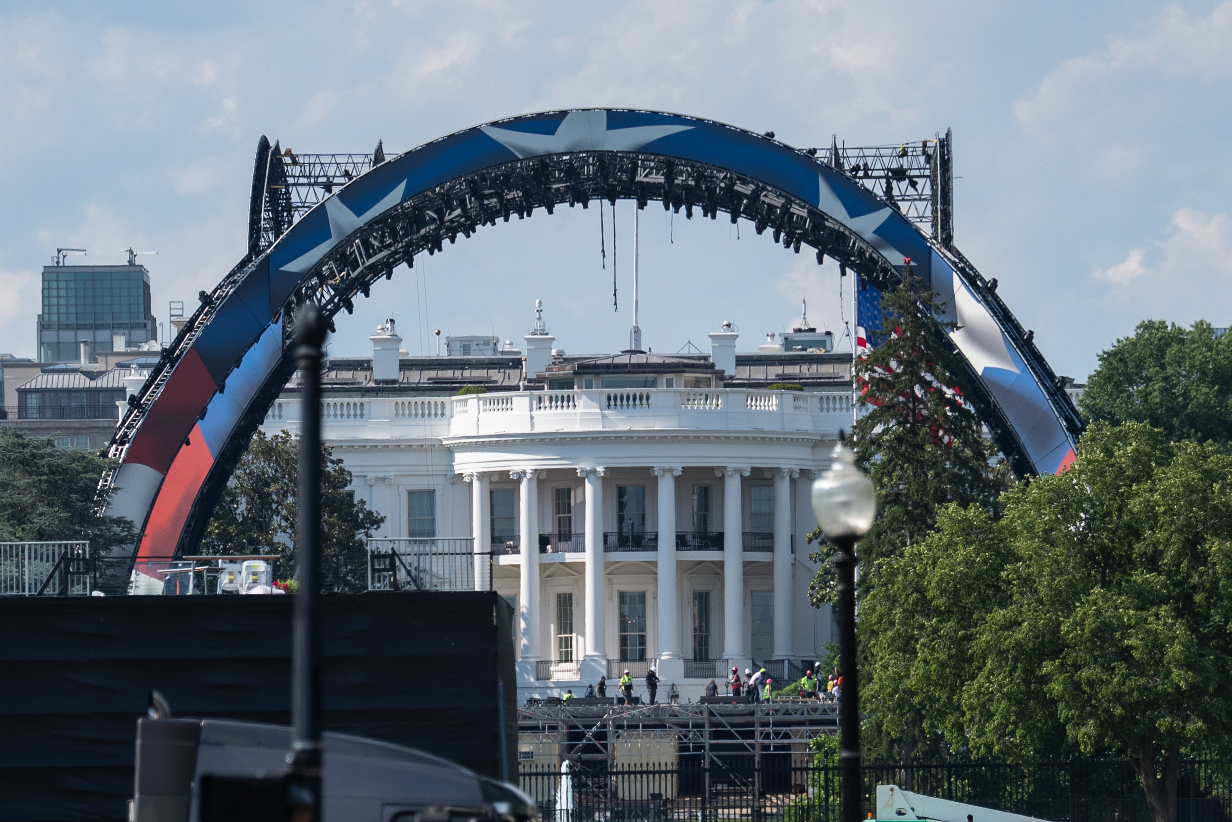 Stage setup successful beforehand of the White House, with a ample arched operation and workers preparing for an event