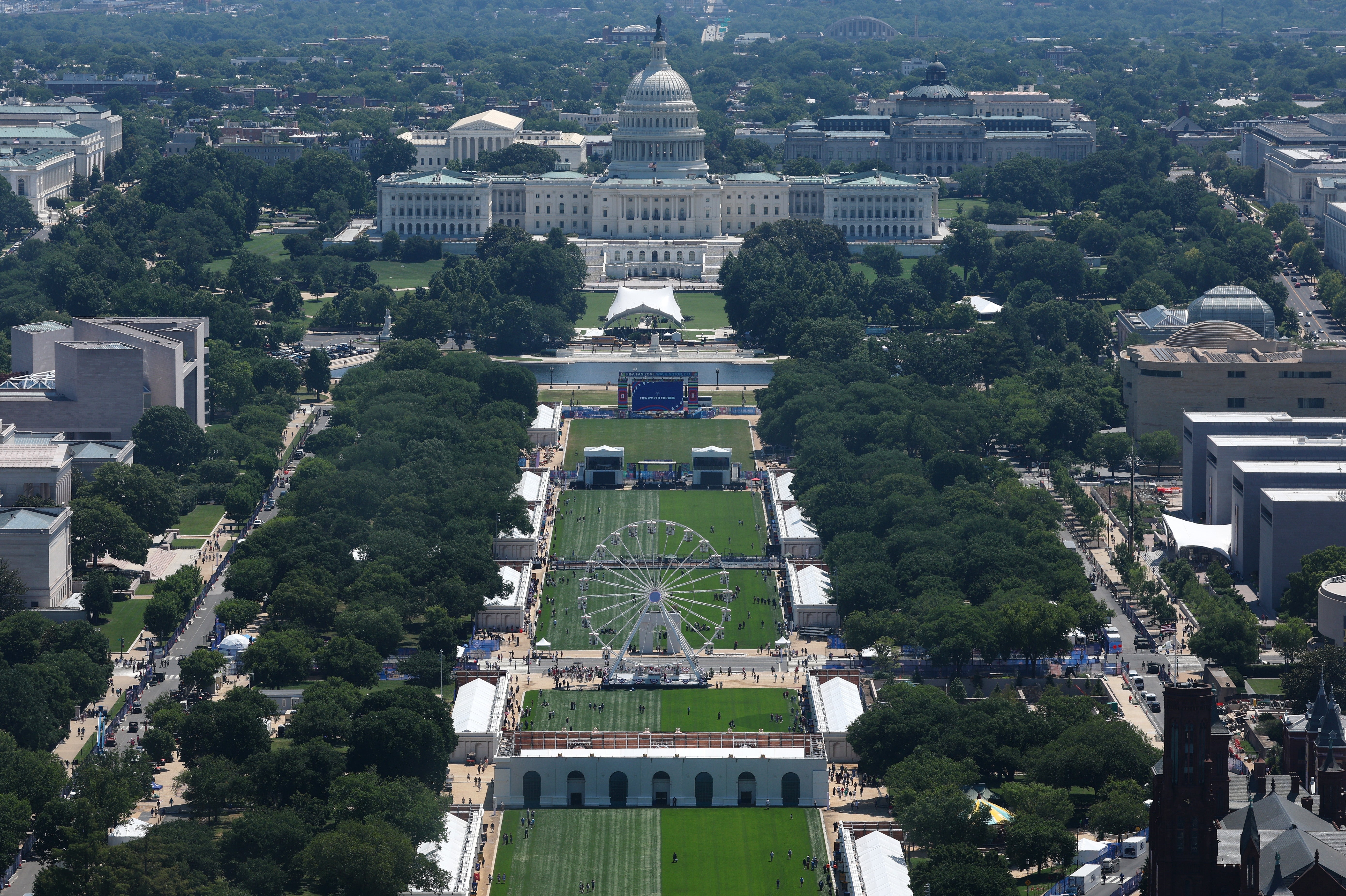 Aerial presumption of the National Mall successful Washington, D.C., with the U.S. Capitol building, a Ferris wheel, and greenish spaces