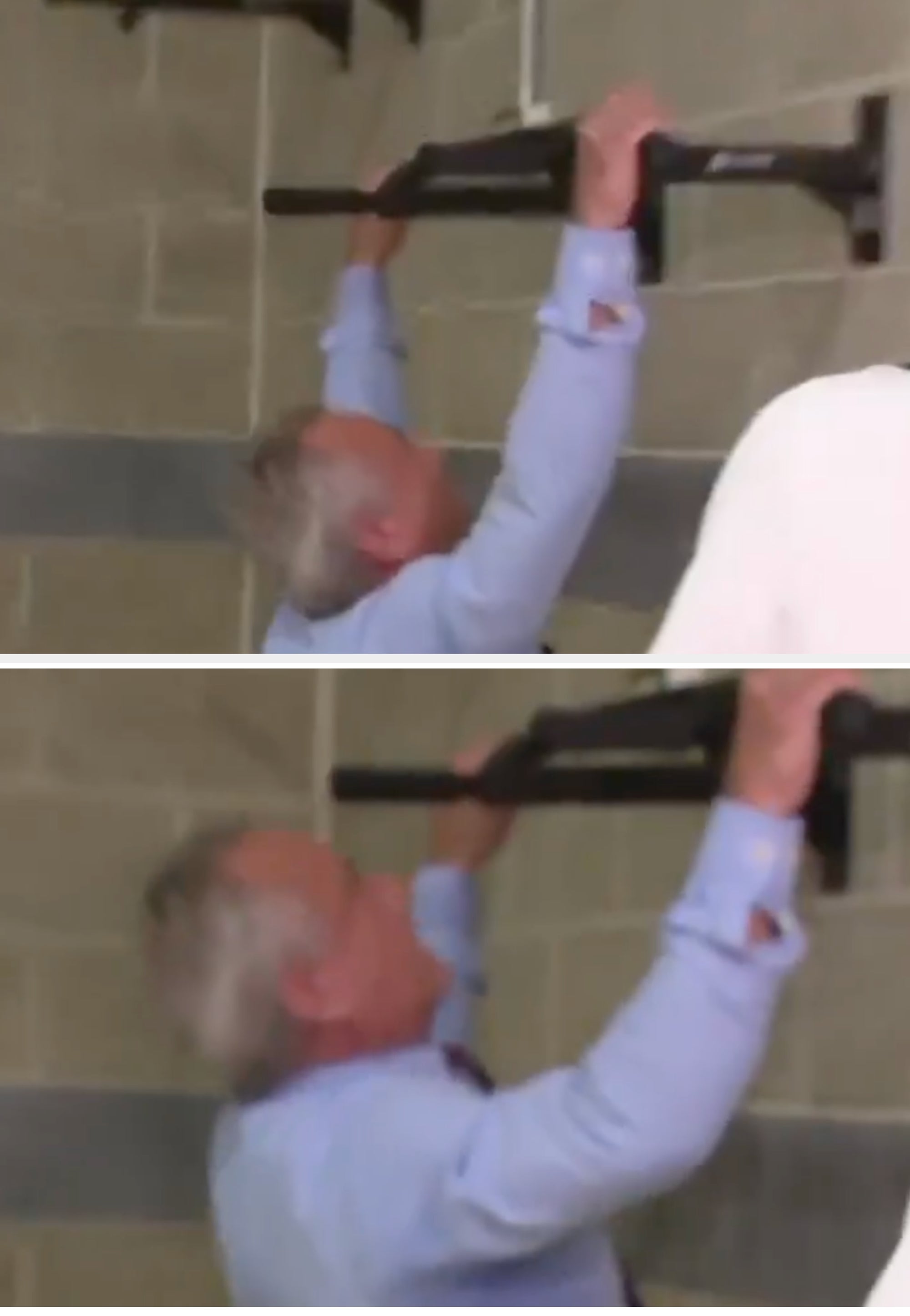 Person attempting a pull-up connected a wall-mounted bar, wearing a long-sleeve shirt, indoors