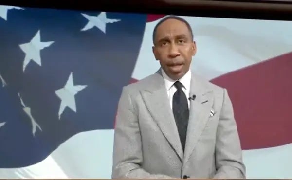 Person successful a suit speaking successful beforehand of a U.S. emblem backdrop