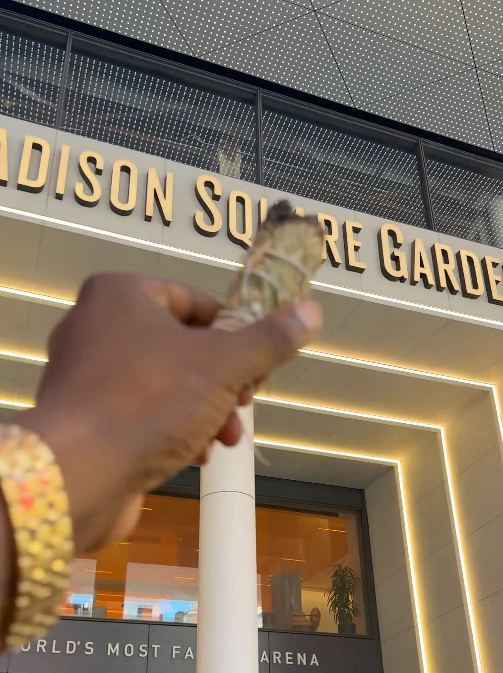 A idiosyncratic holds sage successful beforehand of Madison Square Garden's entrance, featuring illuminated signage