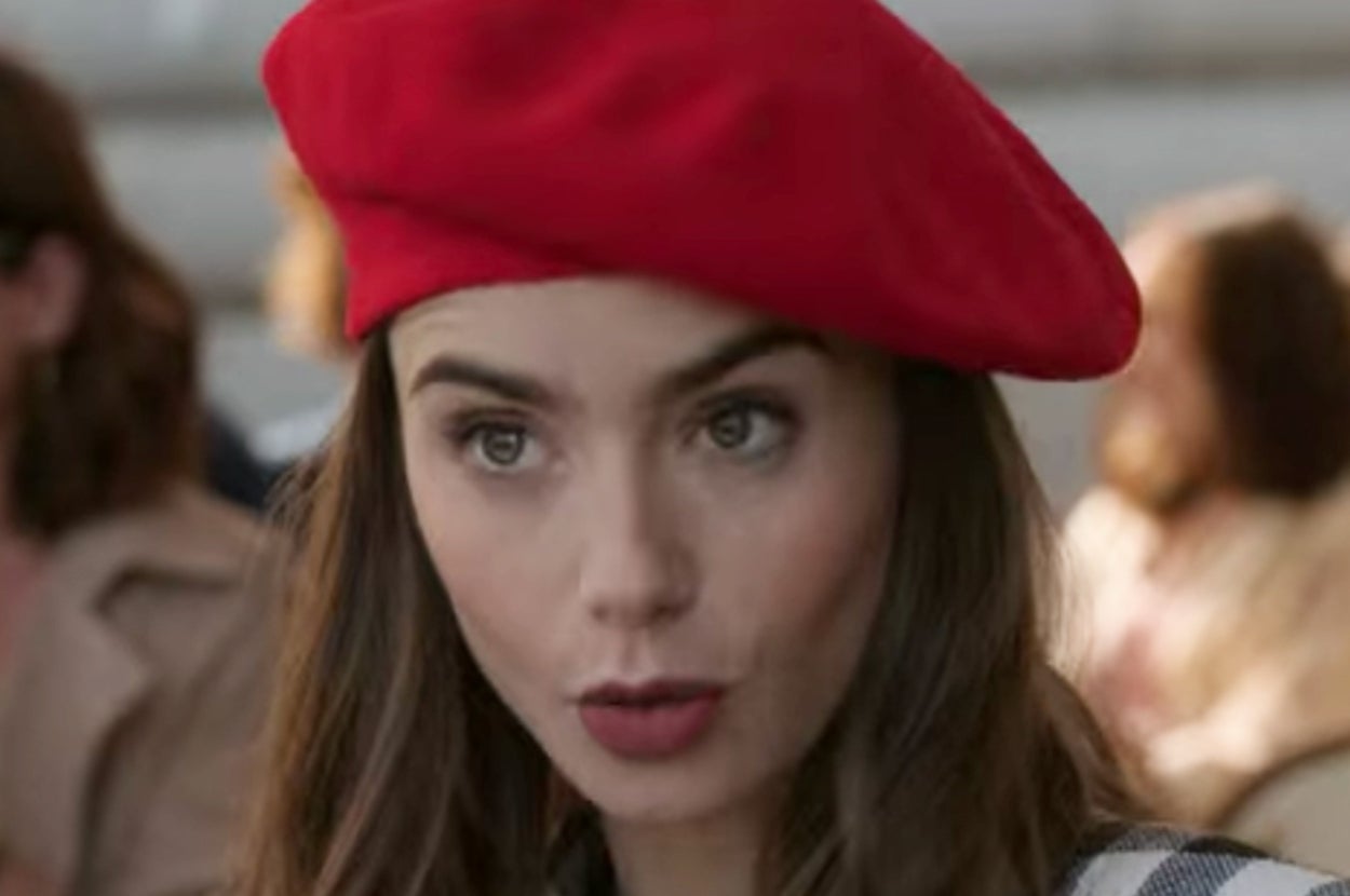 Person wearing a beret speaking animatedly