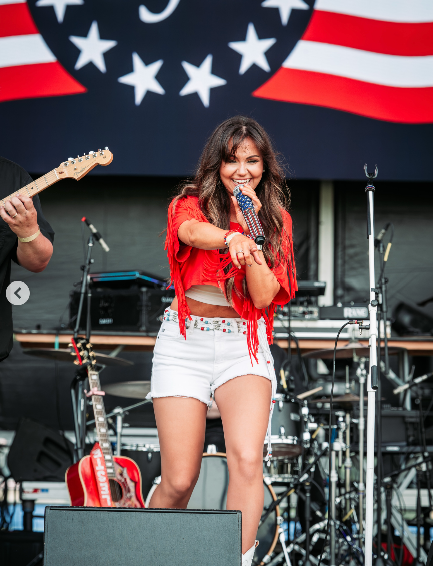 Celeste connected  signifier    performing, with a guitarist cropped out