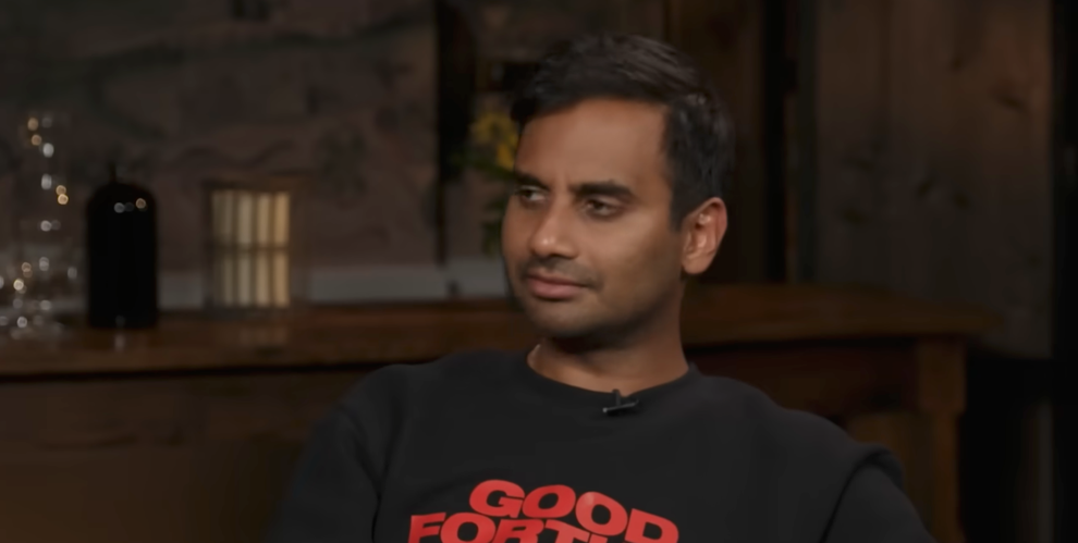 A person sitting in an indoor setting, wearing a sweatshirt that says "Good Fortune."