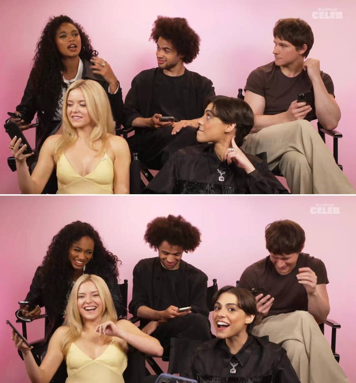 Group of 5  people, sitting together, laughing and chatting. Three clasp  phones. They look    relaxed and informal, progressive   successful  a lively discussion